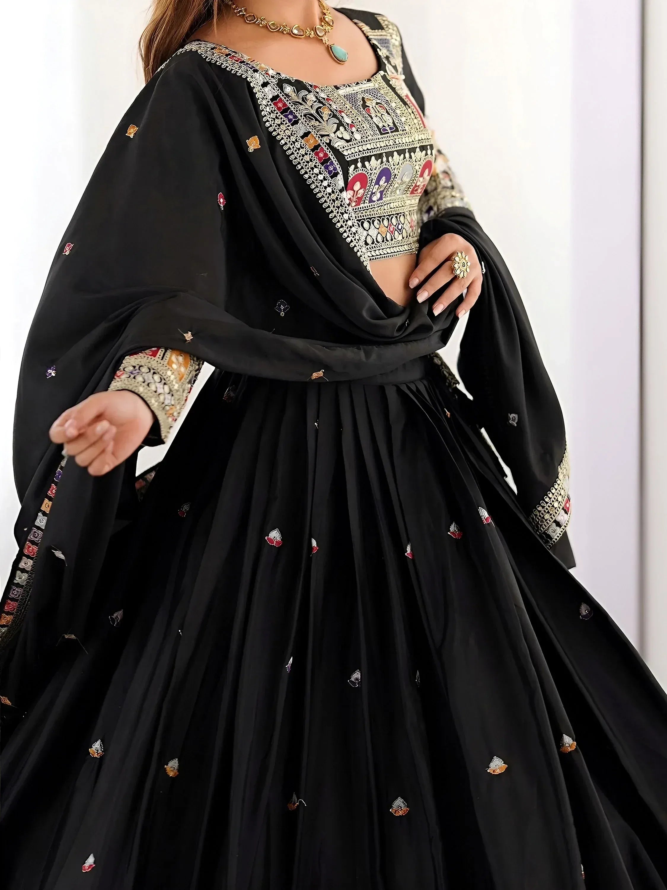Black embroidered lehenga choli with colorful floral motifs and gold detailing, perfect for Indian ethnic wear