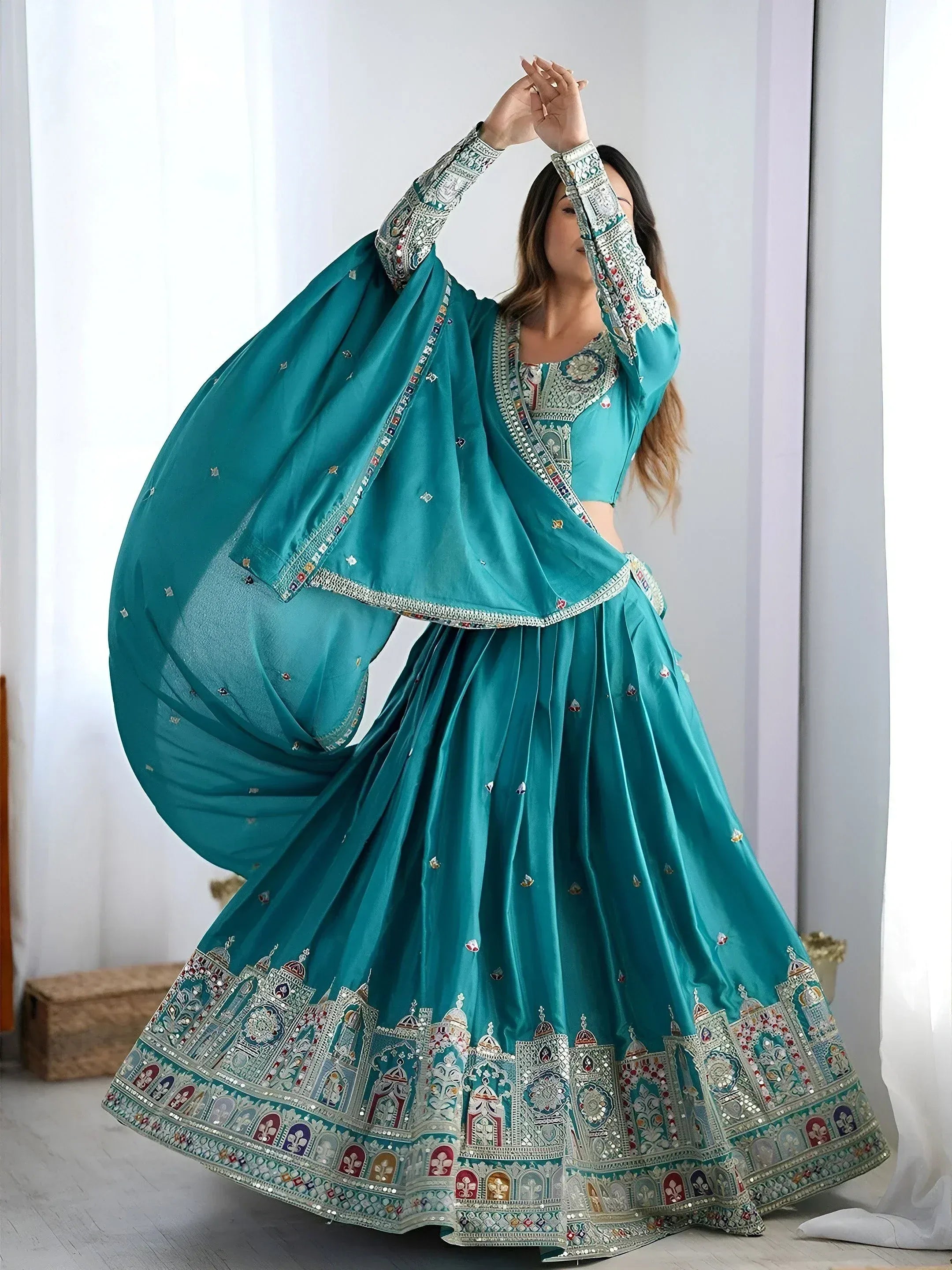 Teal designer lehenga choli with intricate embroidery and mirror work for ethnic occasions