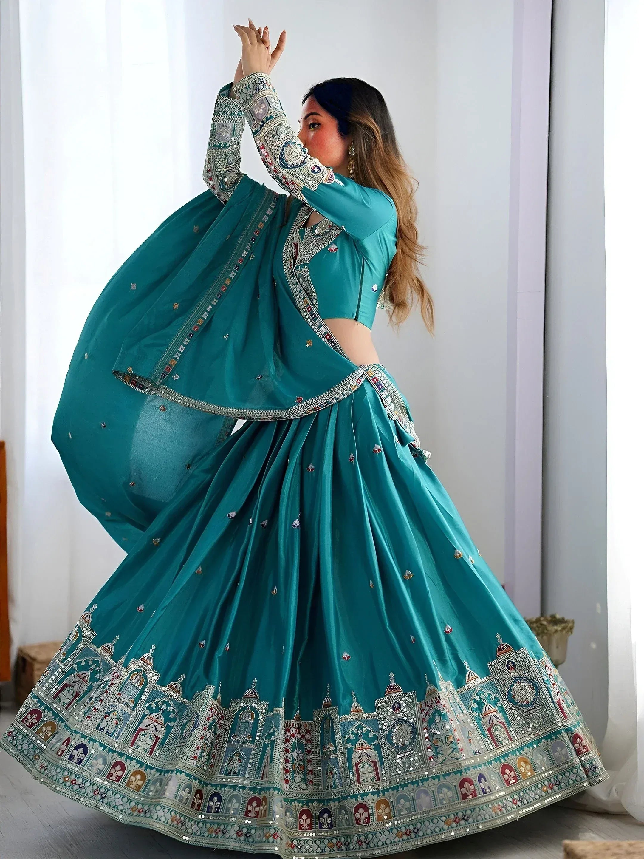 Teal designer lehenga choli with intricate mirror and embroidery work, perfect for Indian ethnic wear occasions