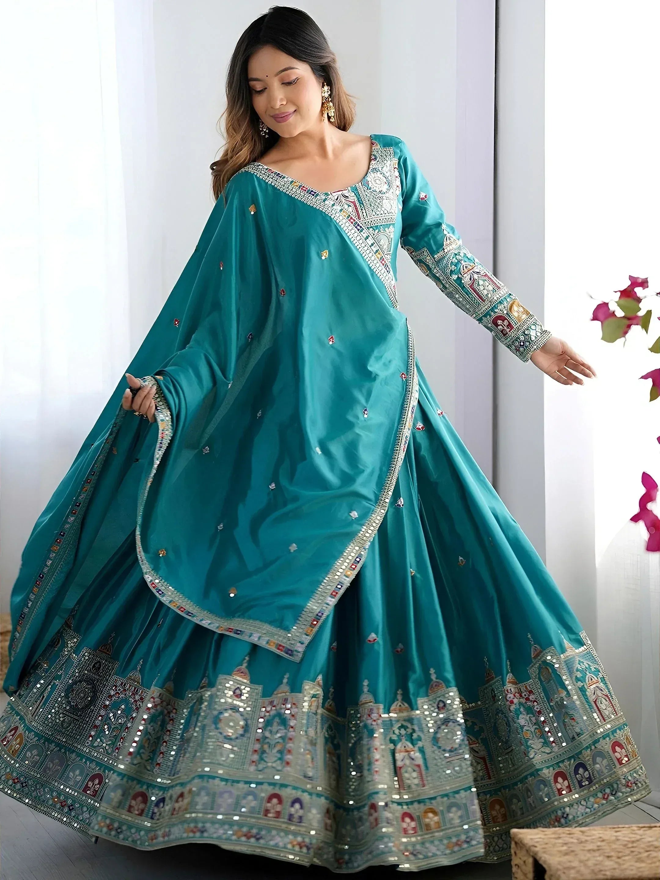 Teal designer lehenga choli with intricate mirror work and embroidery for ethnic wear