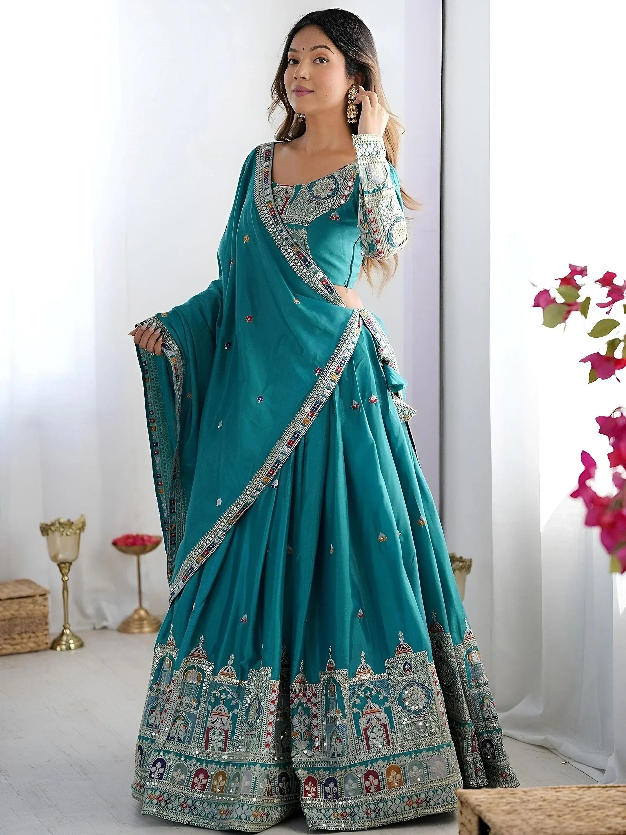Teal designer lehenga choli with intricate embroidery and mirror work, perfect for Indian ethnic wear occasions