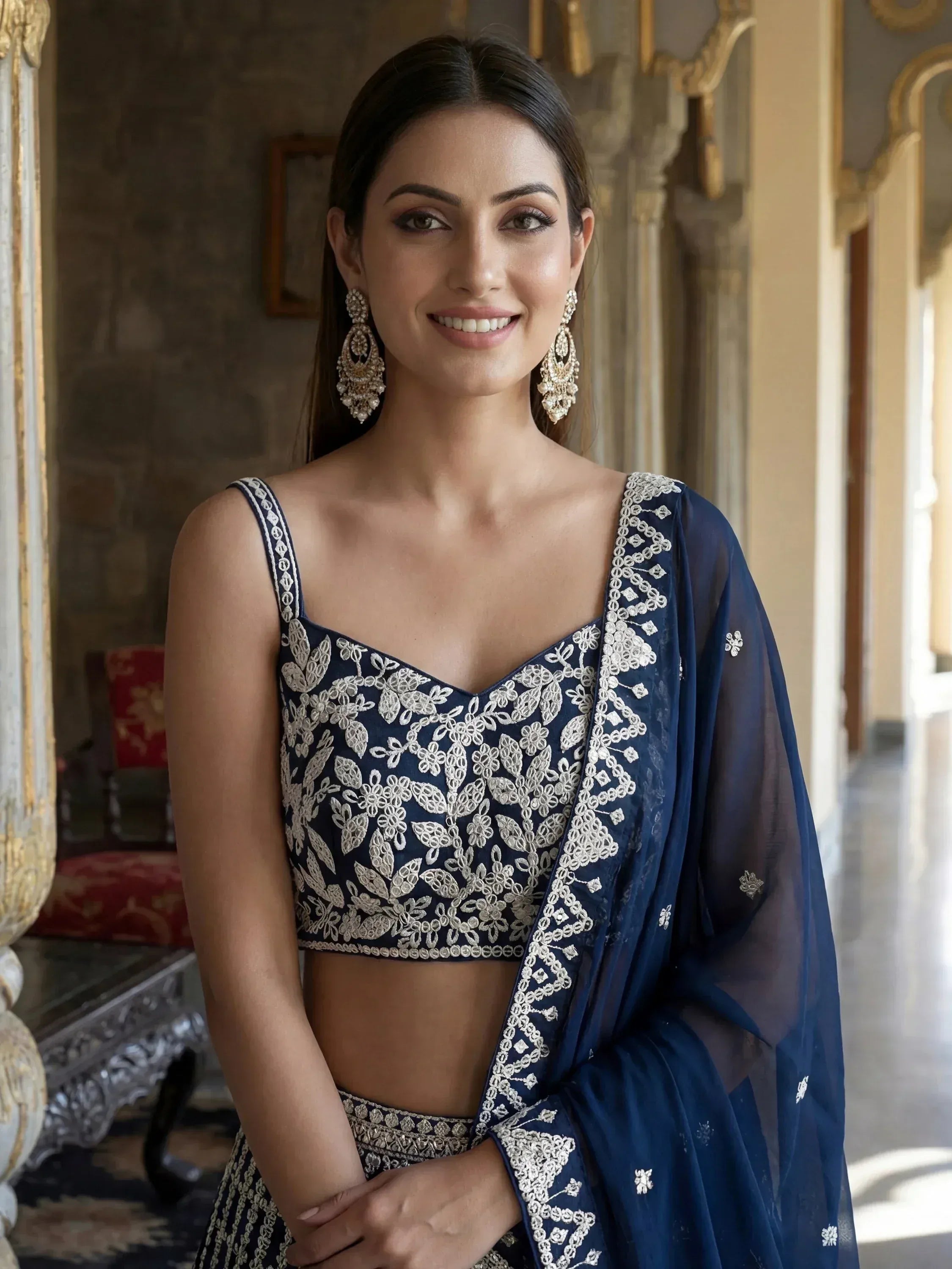 Navy blue embroidered lehenga choli with floral detailing and sheer dupatta, perfect for Indian ethnic occasions.