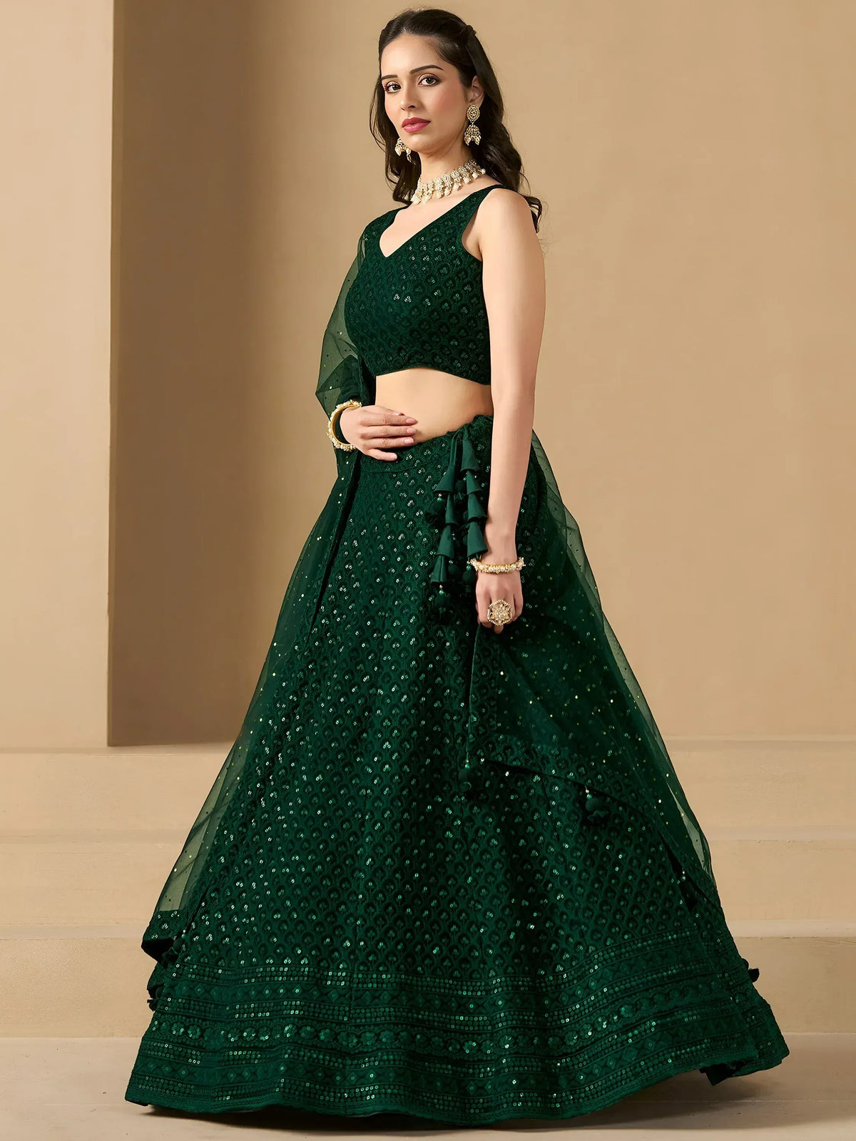 Emerald green designer lehenga choli with sequin embroidery and ruffle details