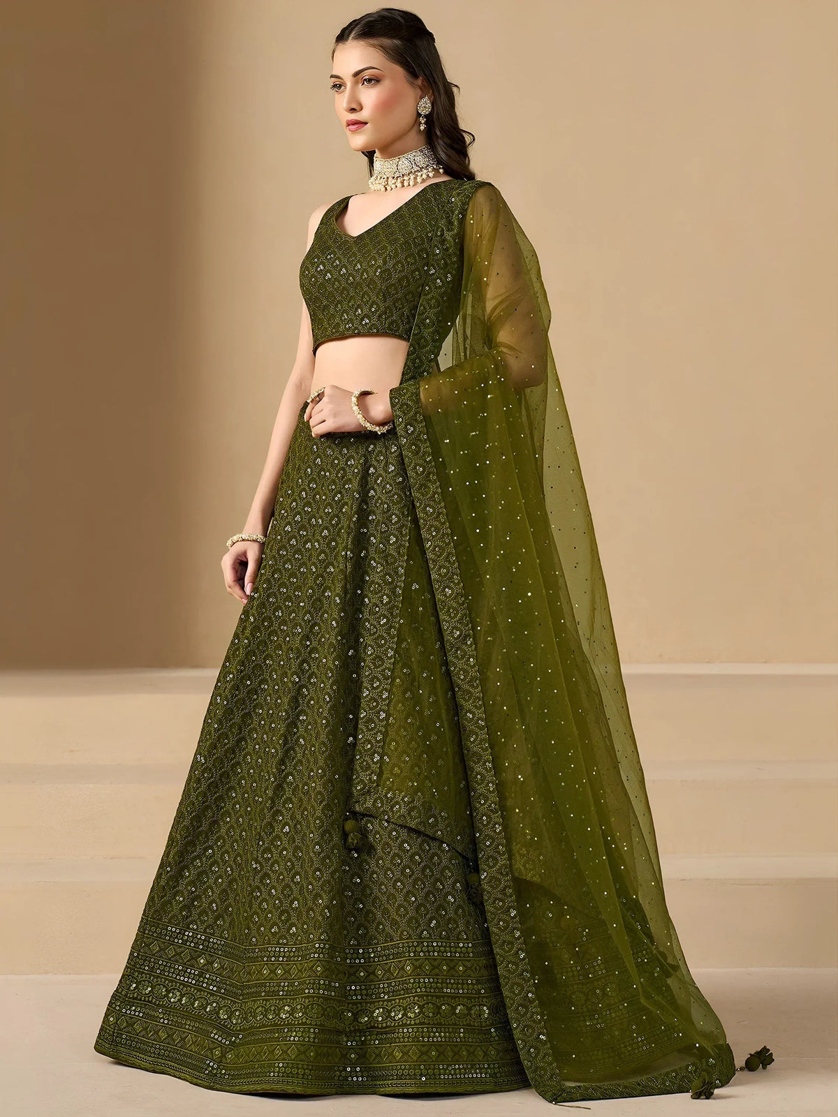 Olive green designer lehenga choli with sequin embroidery and sheer dupatta, perfect for Indian ethnic occasions.