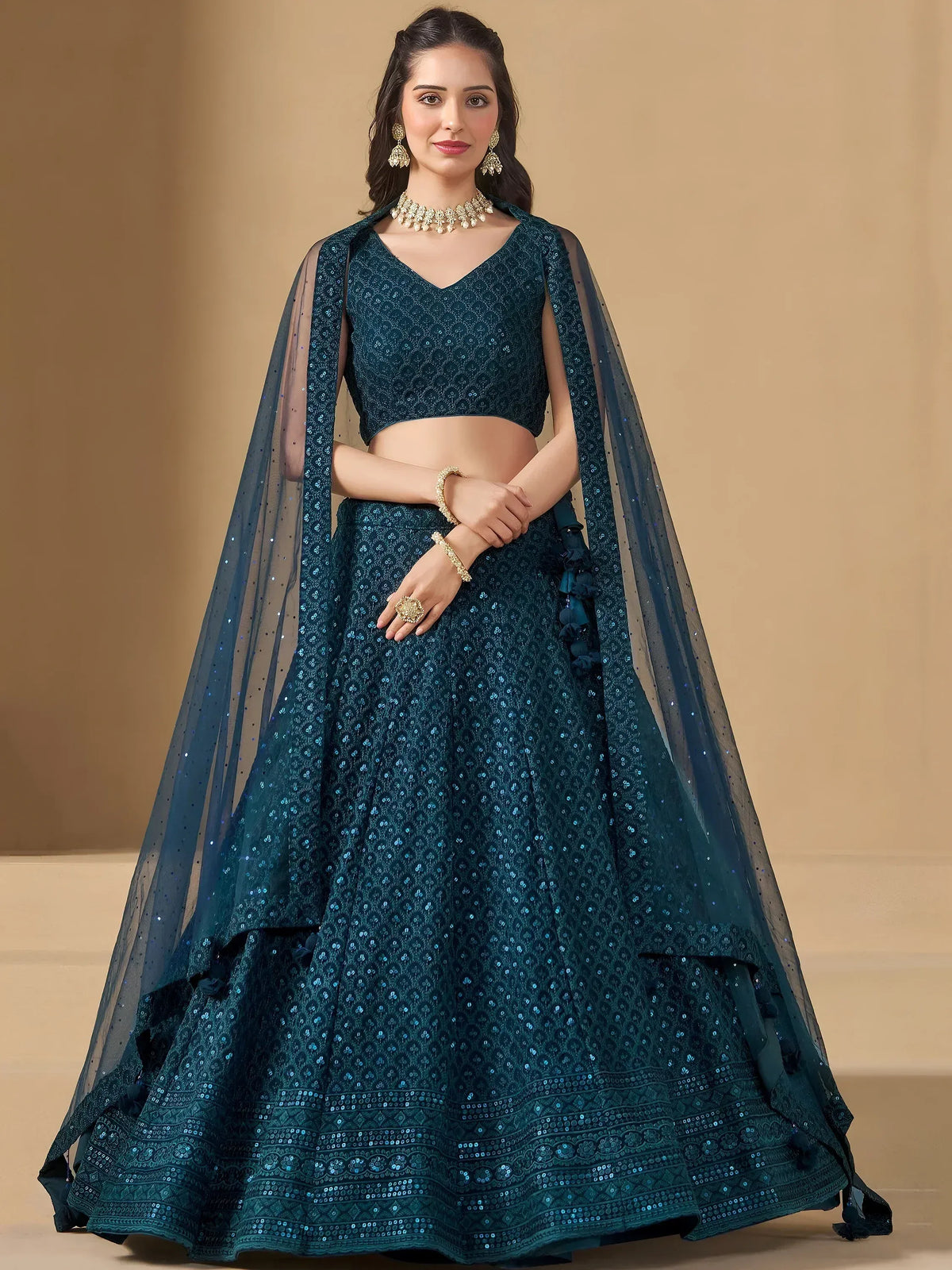 Teal sequin lehenga choli with sheer cape, perfect for Indian weddings and festive occasions.