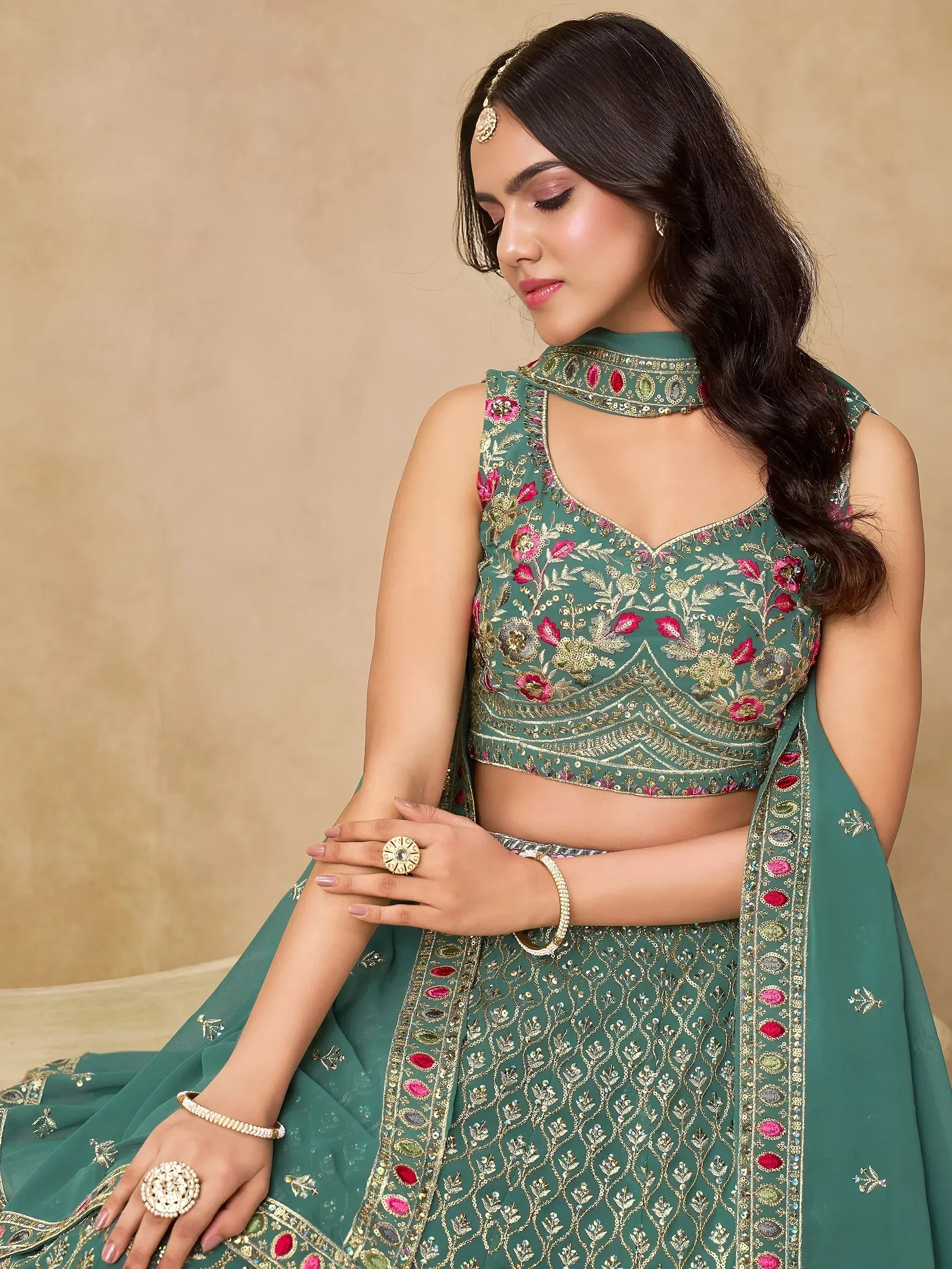 Green floral embroidered lehenga choli with gold detailing, perfect for Indian ethnic wear occasions.