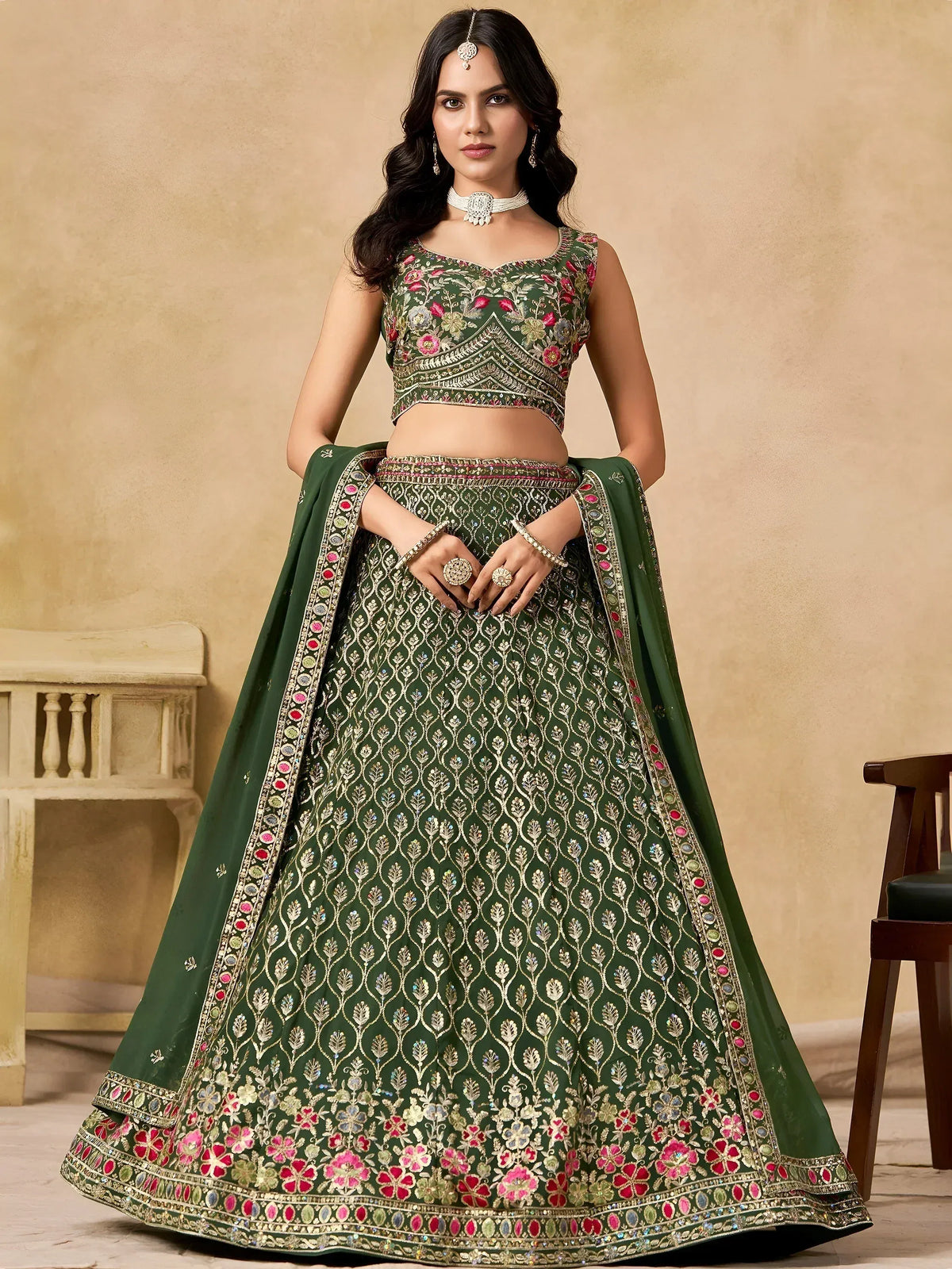 Green embroidered lehenga choli with floral motifs and gold detailing, perfect for Indian ethnic wear