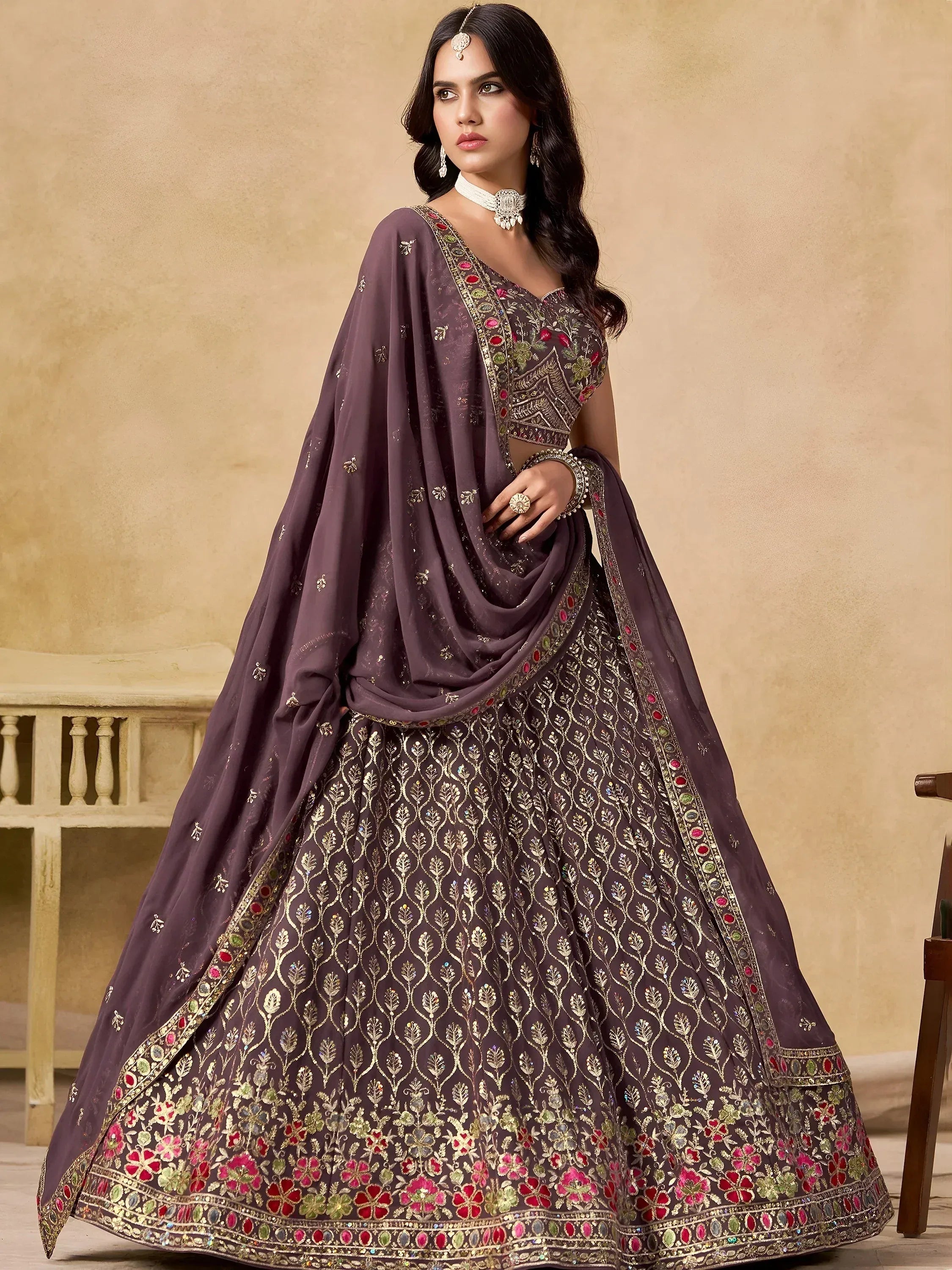 Elegant purple lehenga choli with gold embroidery and floral motifs, perfect for Indian ethnic wear occasions.