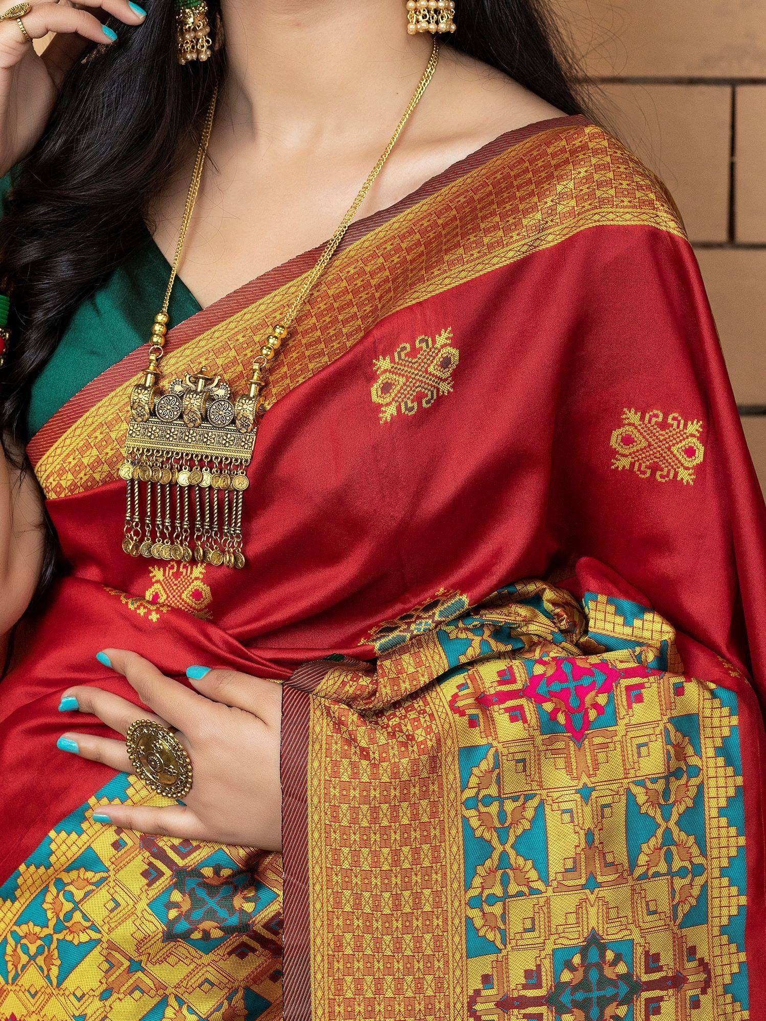 Red and gold embroidered saree with traditional jewelry, perfect for Indian ethnic wear occasions