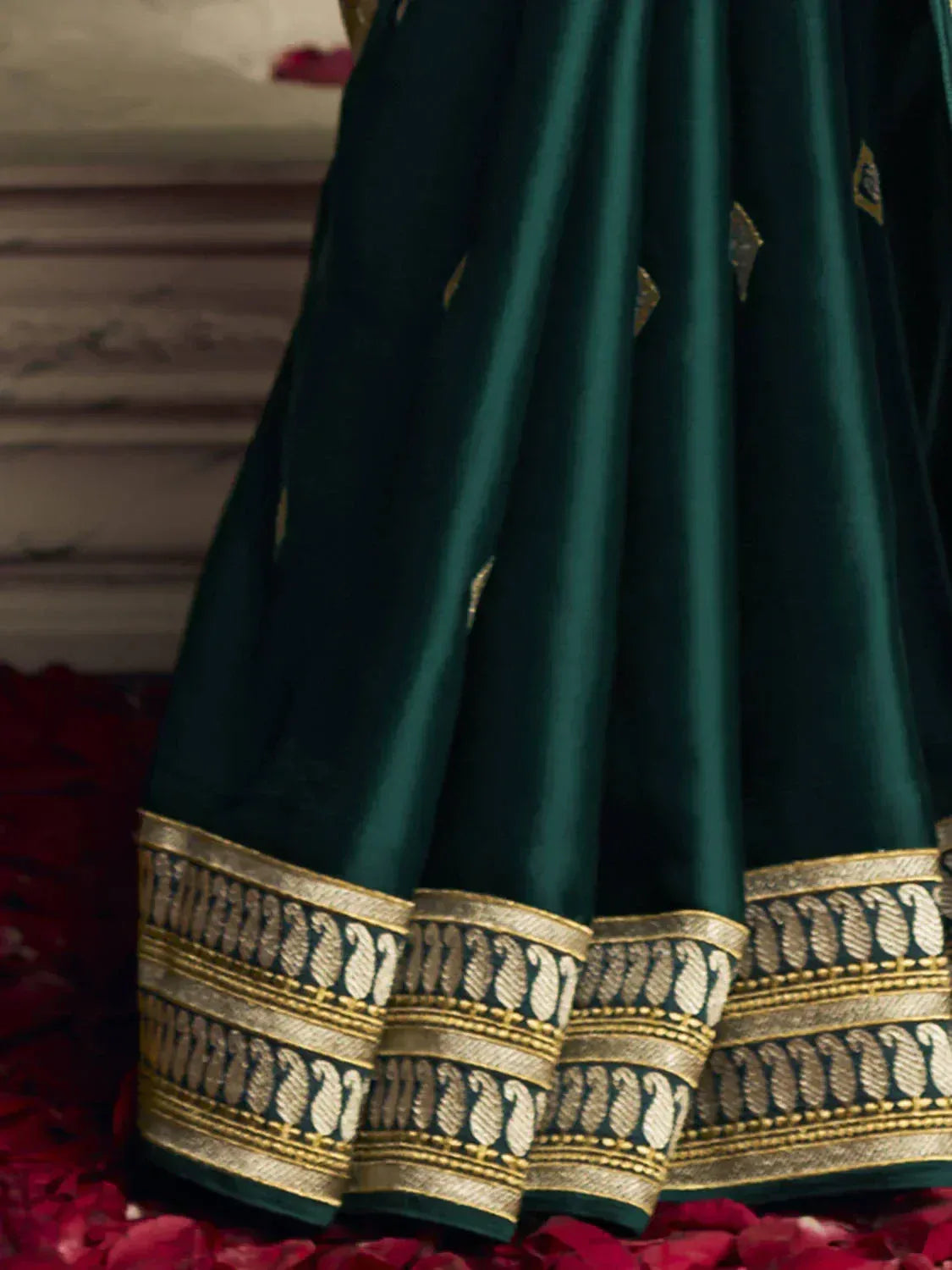 Emerald green lehenga with gold paisley border, perfect for Indian ethnic wear occasions