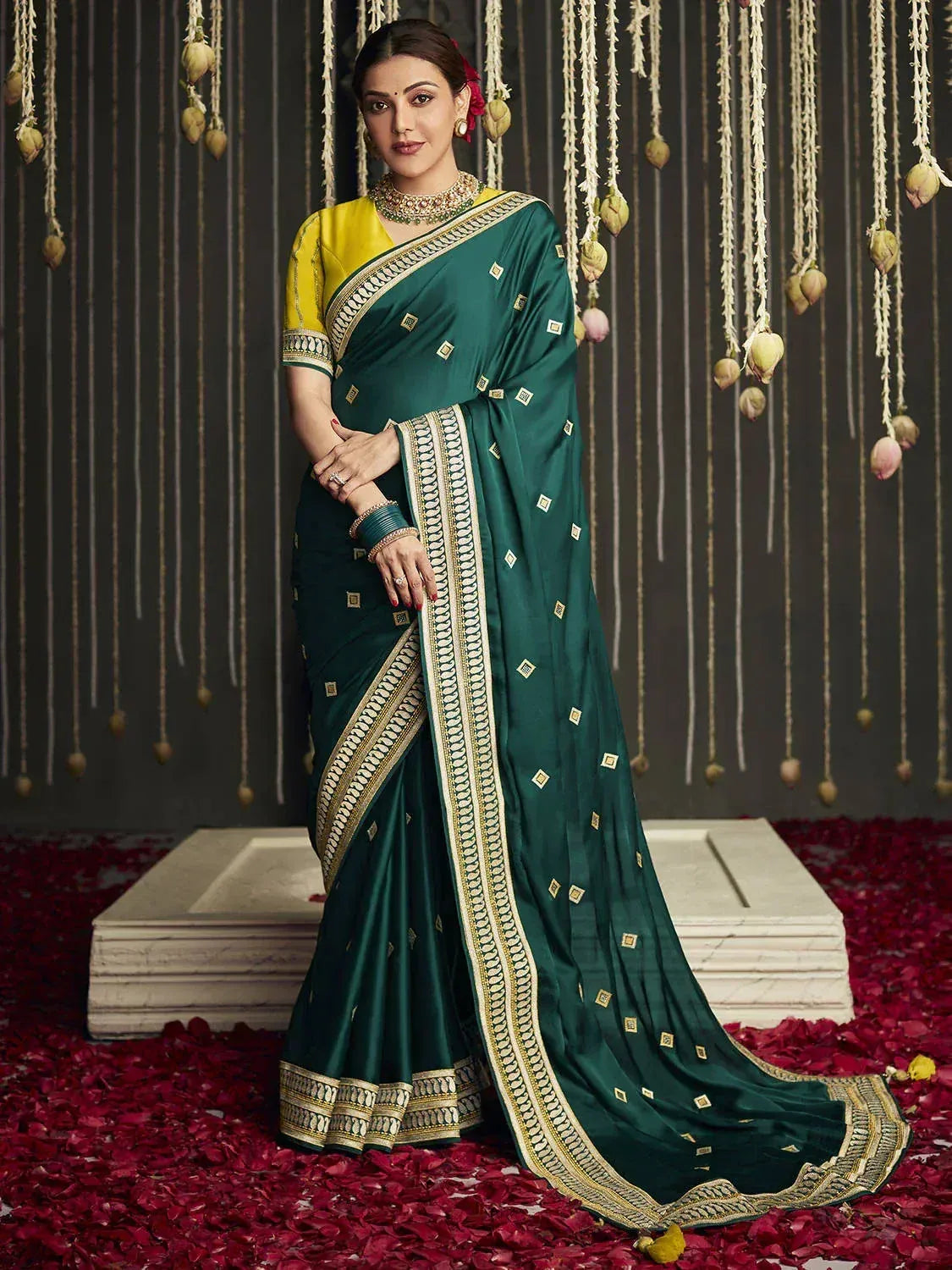 Emerald green saree with gold border and yellow blouse, styled for Indian ethnic wear occasions