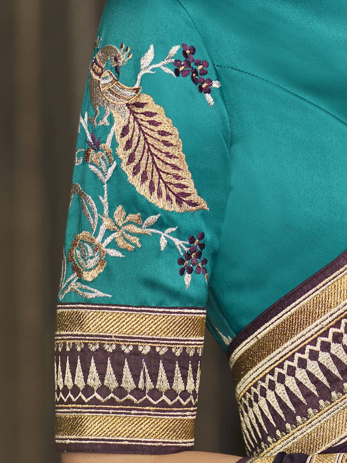 Teal ethnic blouse with peacock and floral embroidery, gold border detail
