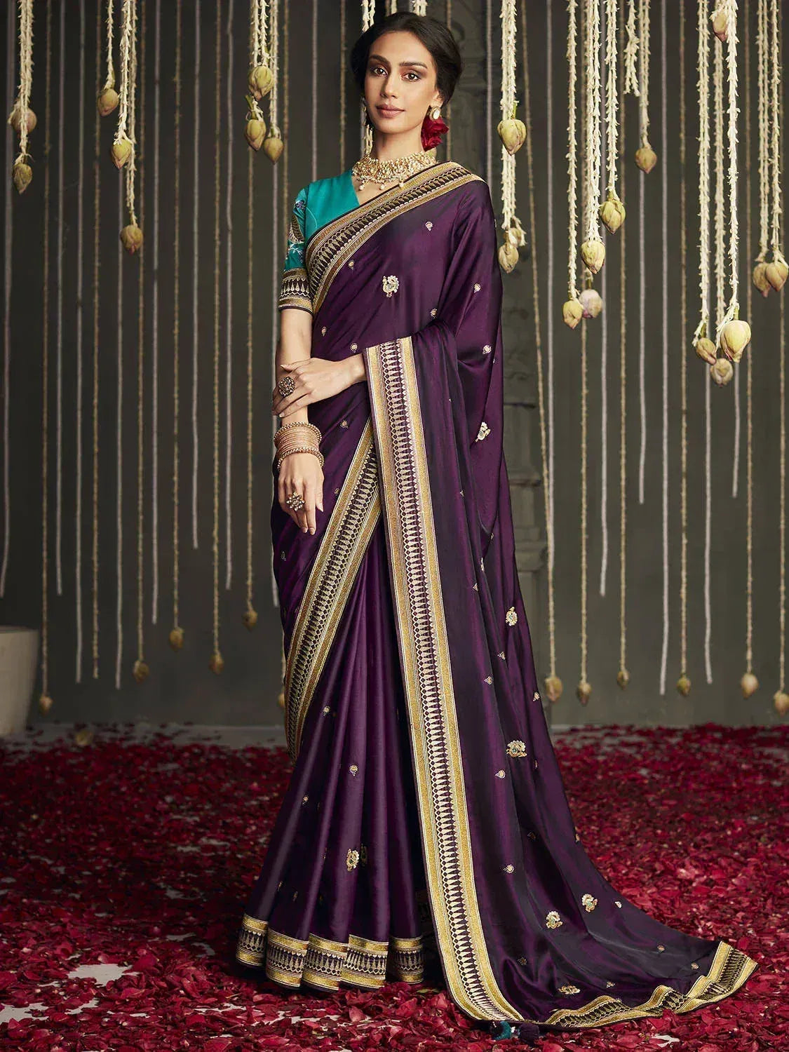 Elegant purple saree with gold embroidery and border, paired with teal blouse, perfect for Indian ethnic occasions