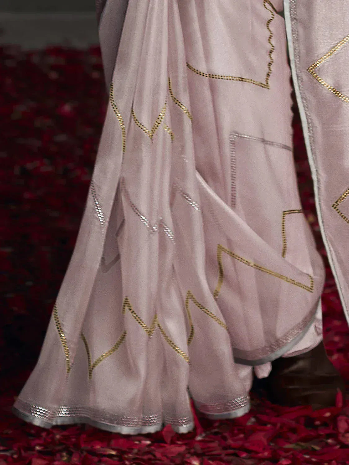 Pink ethnic saree with gold zigzag embroidery, perfect for Indian weddings and festive occasions.