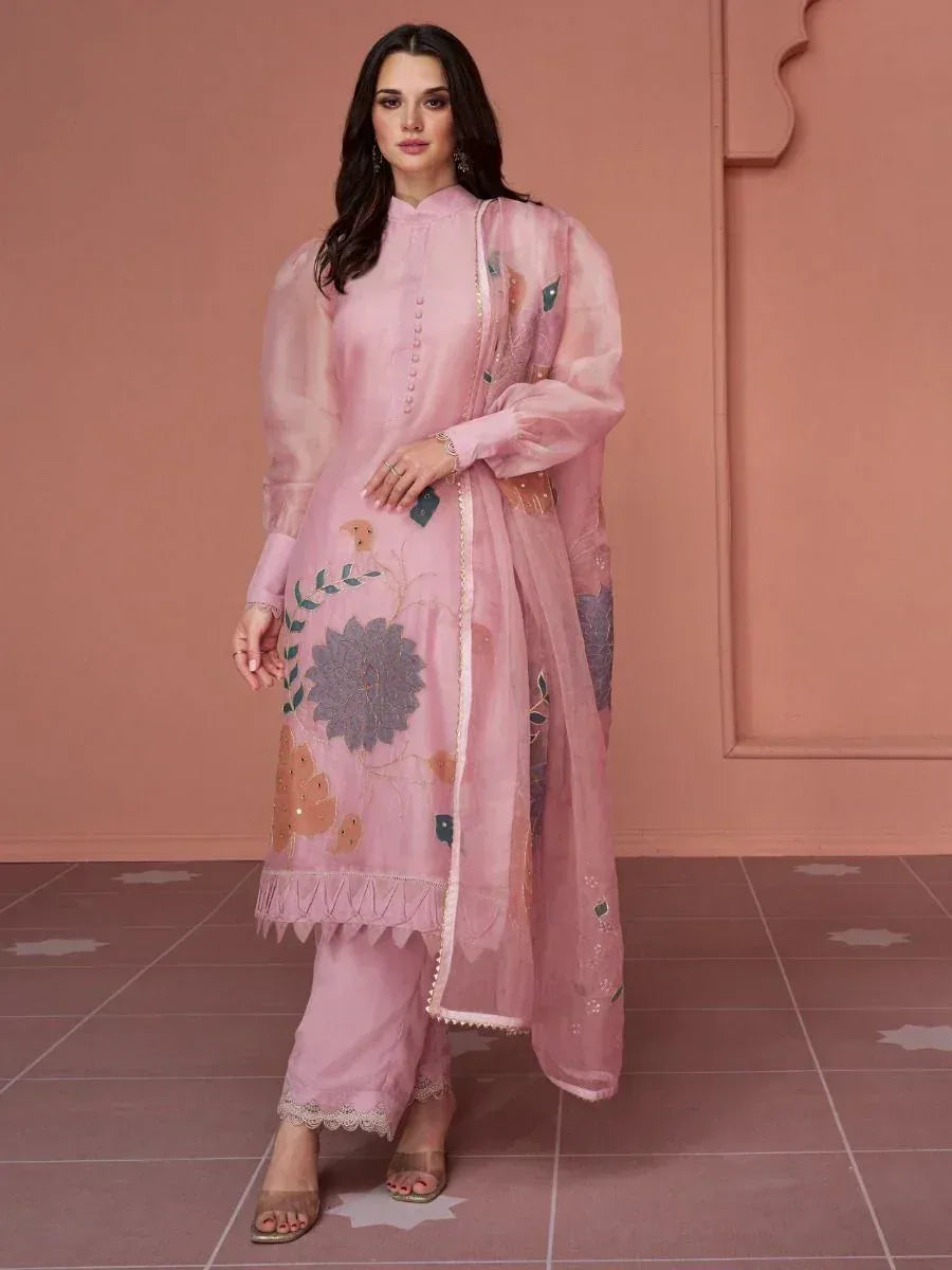 Woman wearing pastel pink embroidered salwar kameez with dupatta, ethnic Indian outfit