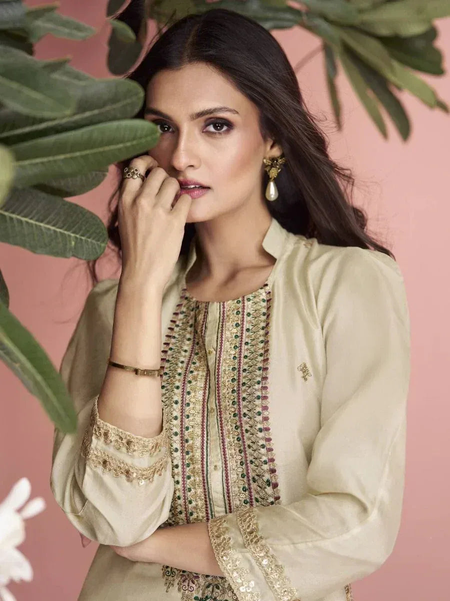 Elegant beige embroidered kurta with green and gold detailing, styled for Indian ethnic wear