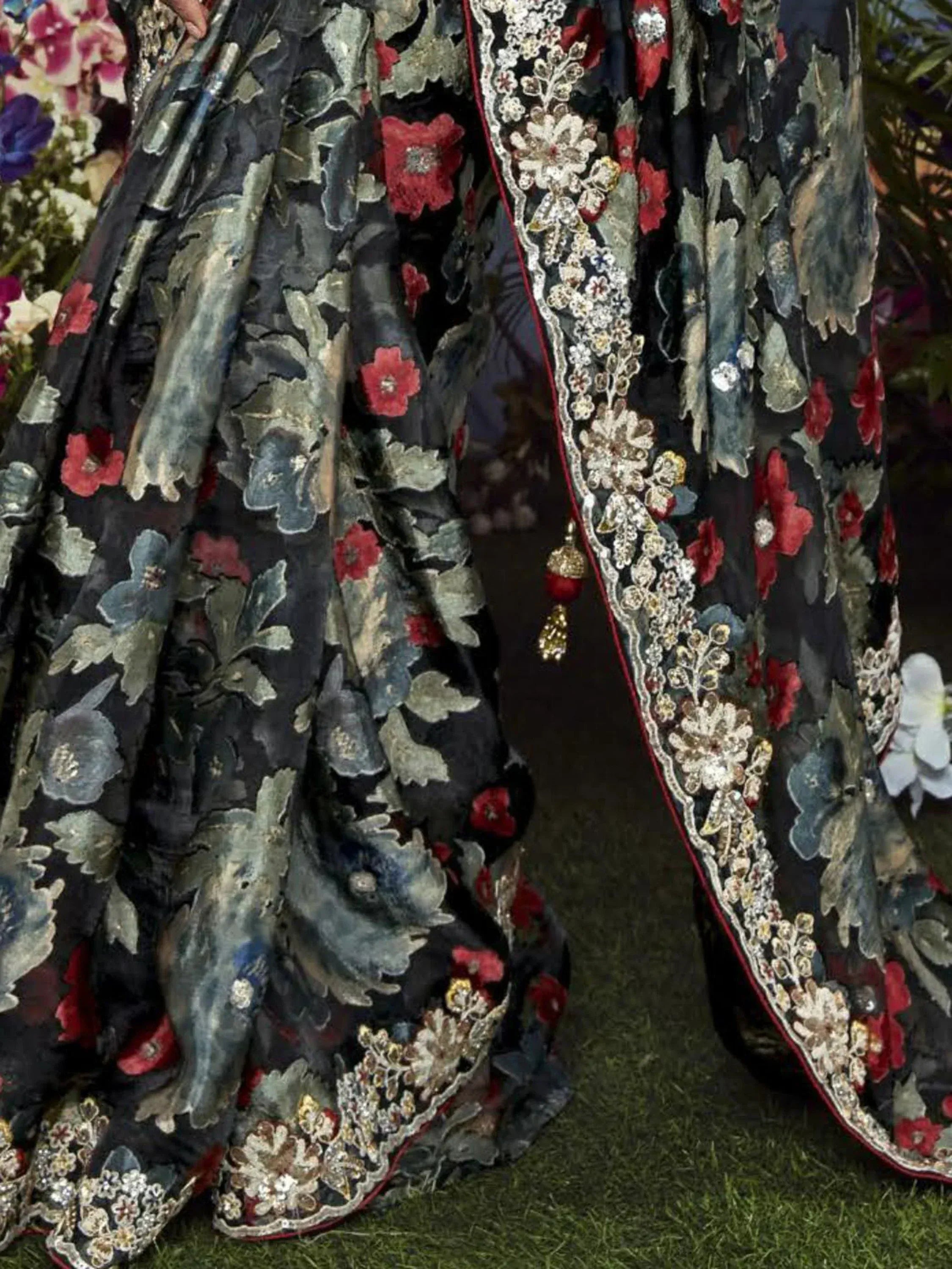 Black floral embroidered lehenga with red and gold detailing, perfect for Indian ethnic wear
