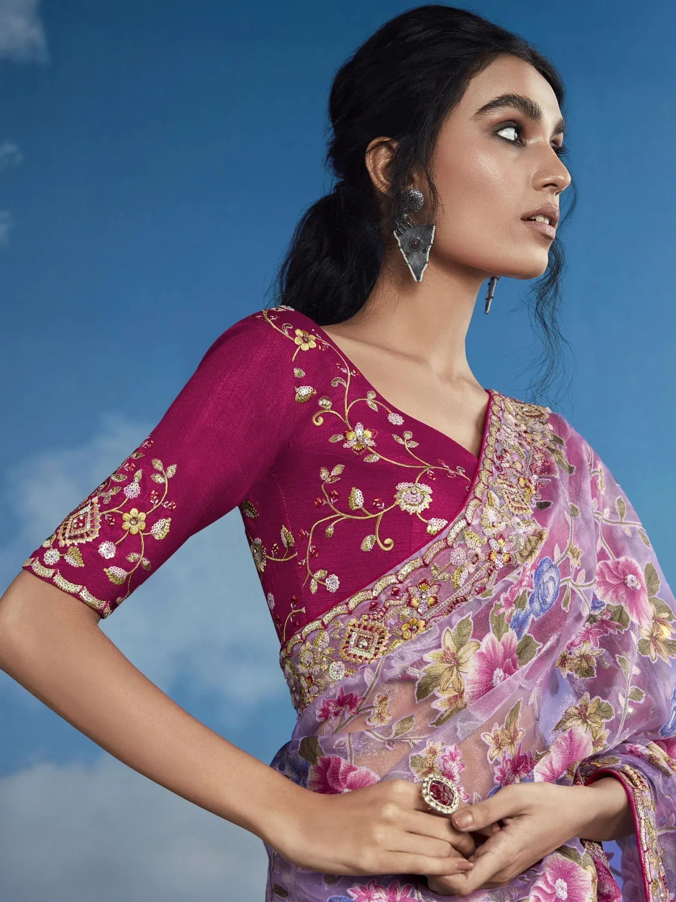 Woman in maroon embroidered blouse with floral saree, ethnic Indian wear