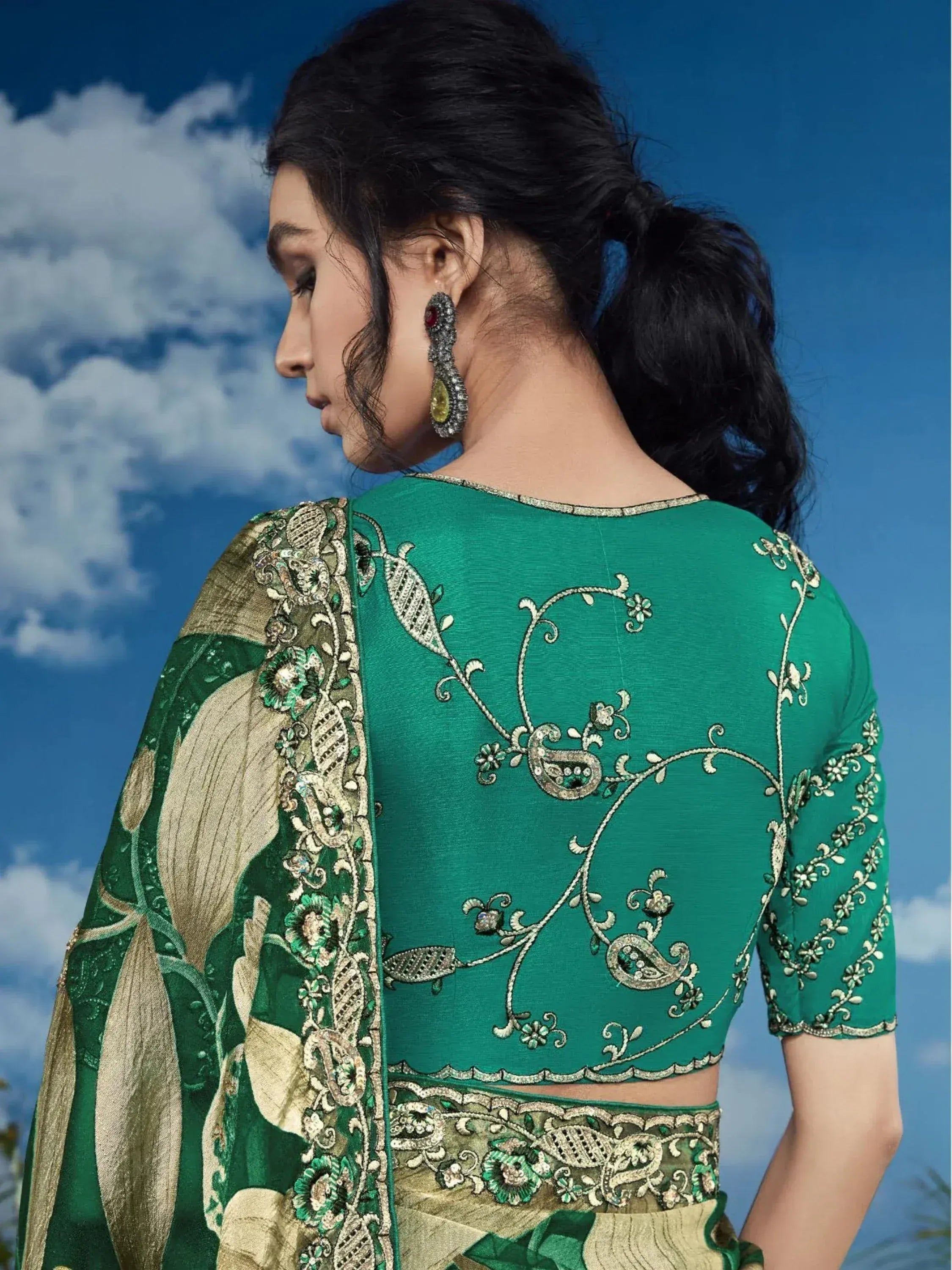 Green embroidered designer lehenga choli with gold floral detailing and paisley back design