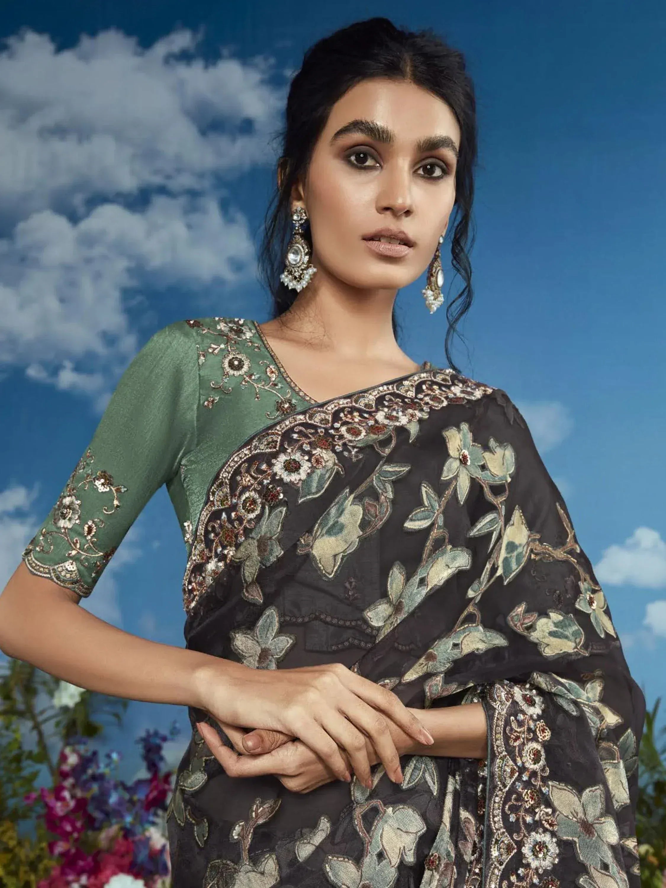 Elegant black floral embroidered saree with green blouse, perfect for Indian ethnic wear occasions.