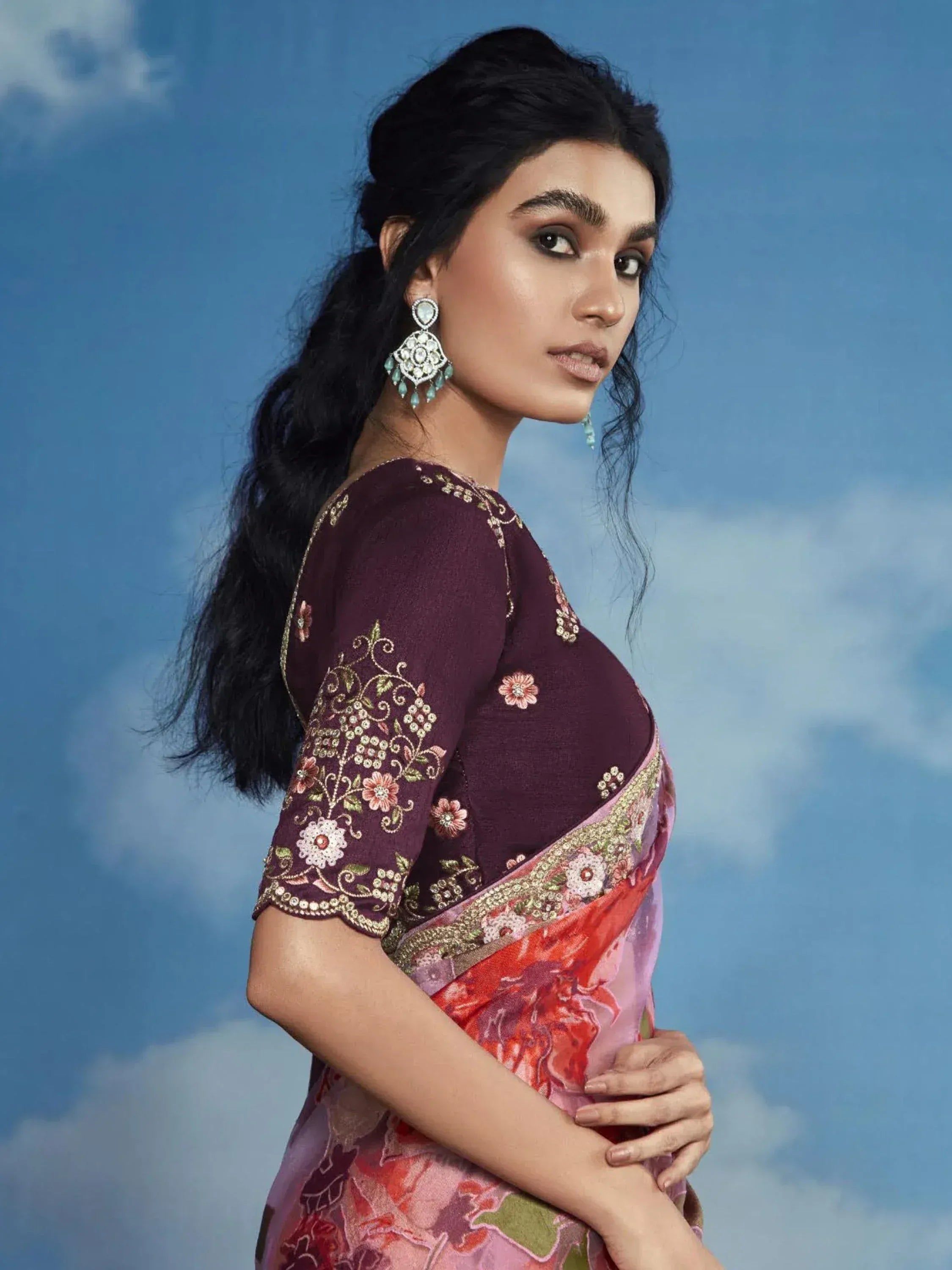 Woman in embroidered maroon blouse with floral pink saree, traditional Indian ethnic wear