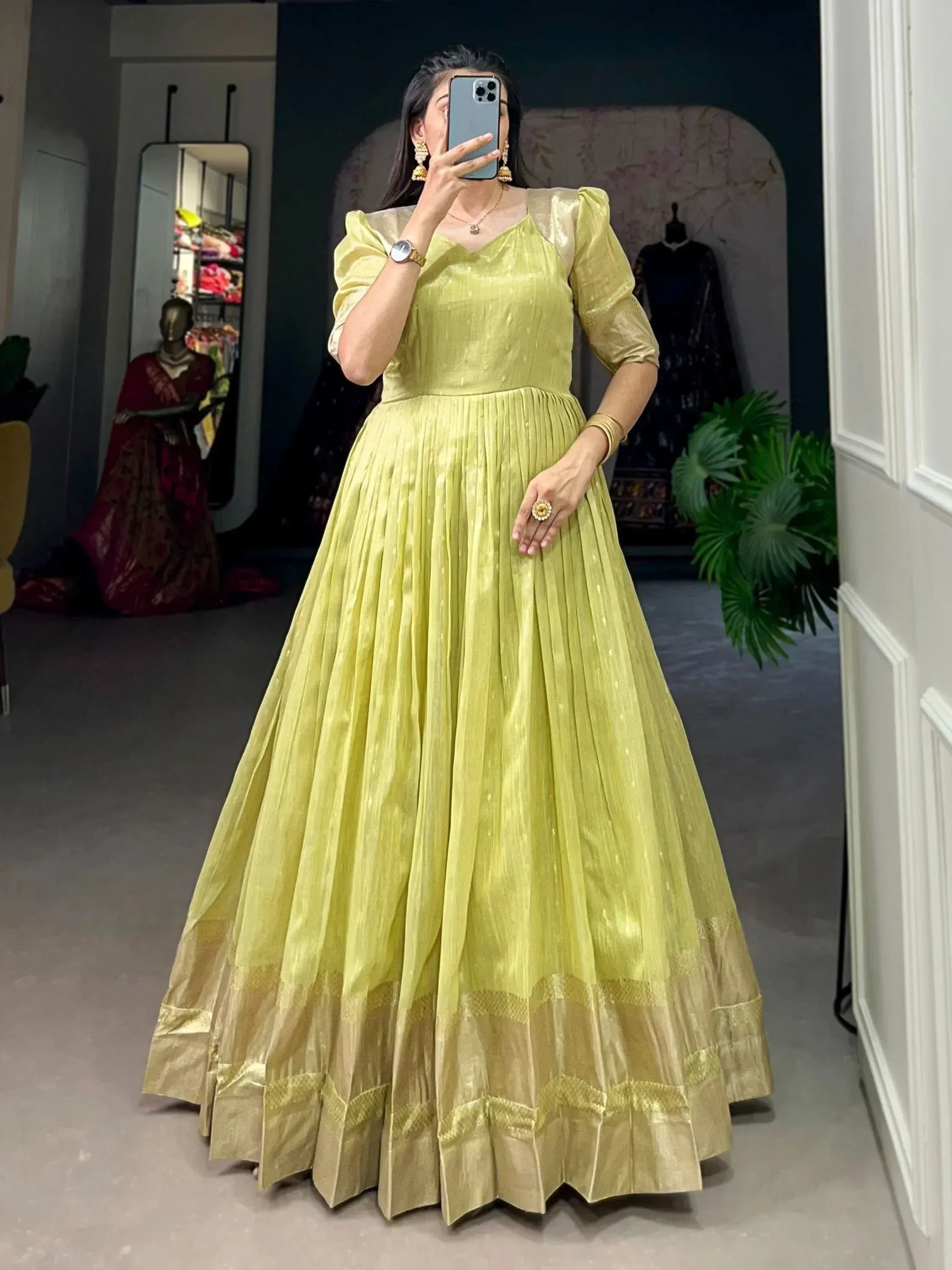 Lime green ethnic gown with pleated skirt and puff sleeves, perfect for Indian occasions