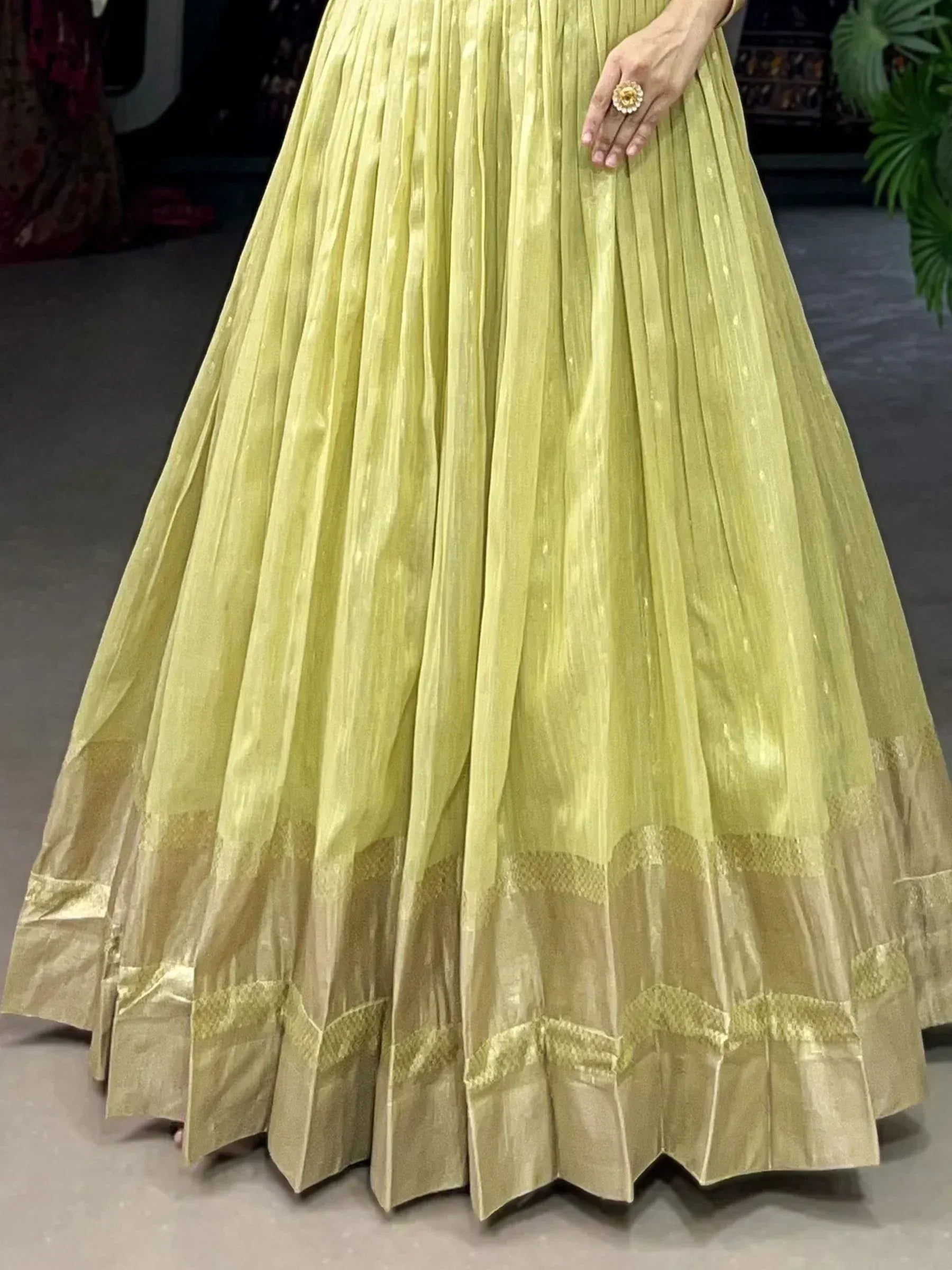 Light green pleated ethnic gown with golden border, perfect for Indian occasions