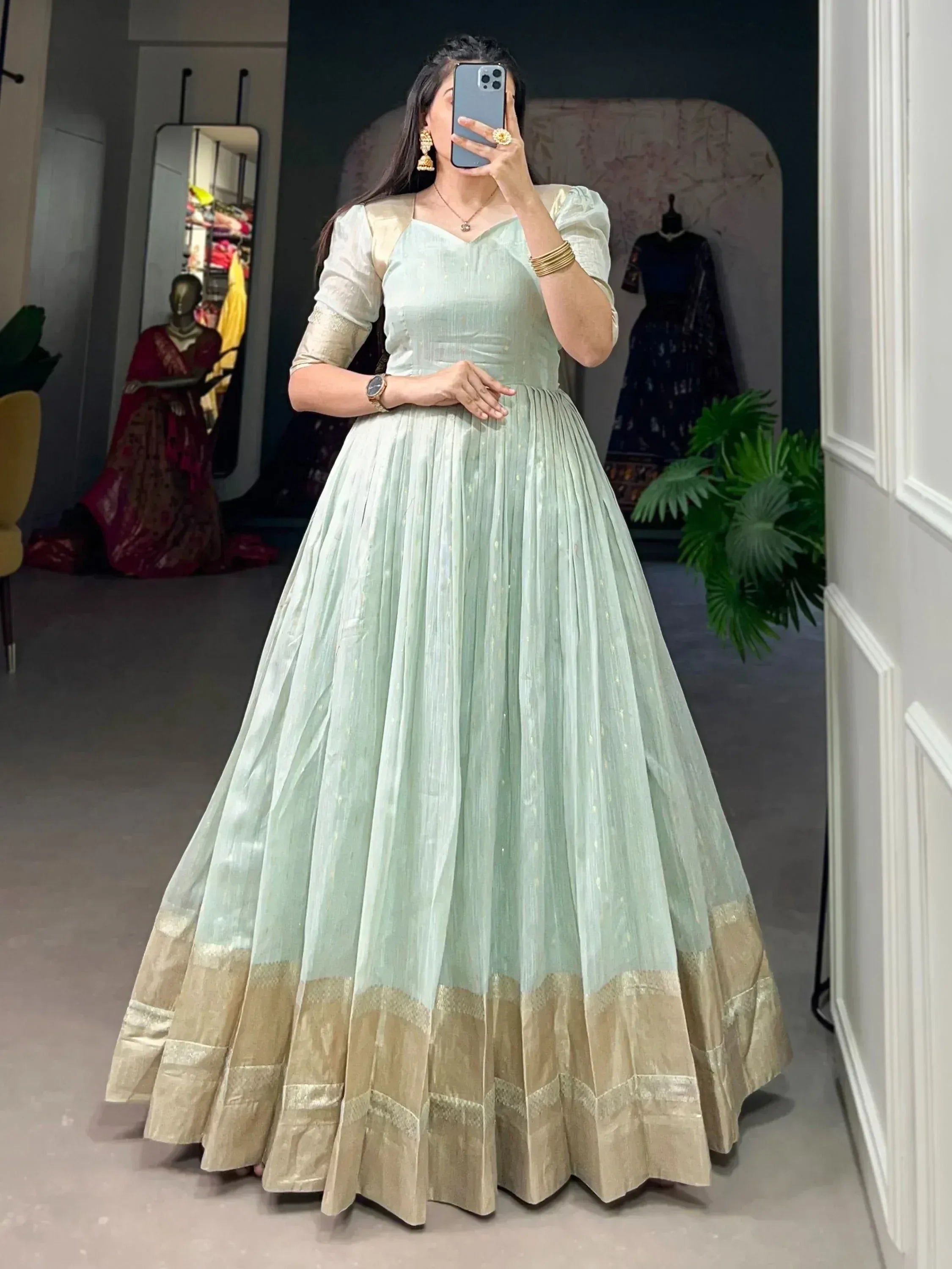 Mint green ethnic gown with gold border, puff sleeves, perfect for Indian occasions and festive wear.