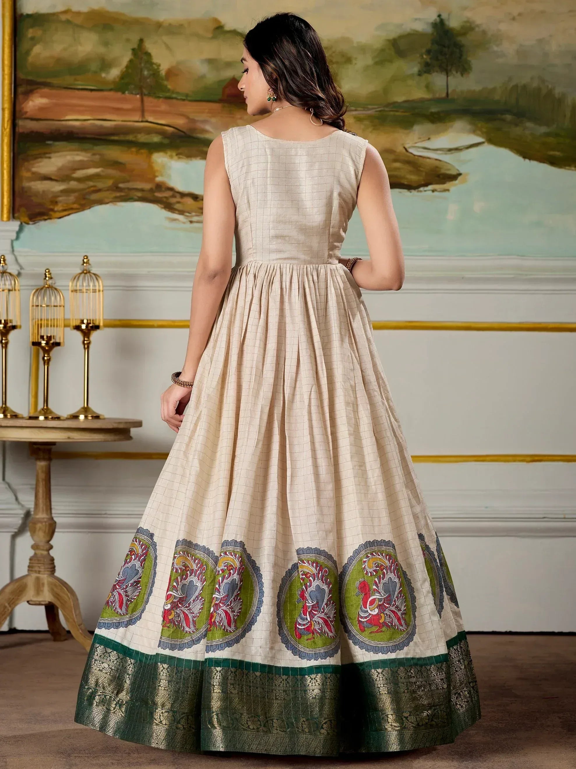 Beige checkered ethnic gown with peacock print hem and green border, perfect for Indian occasions