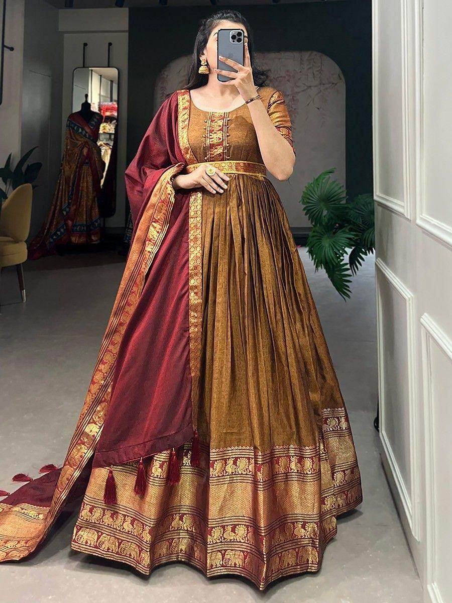 Elegant gold and maroon lehenga choli with intricate embroidery and tassels, perfect for festive occasions.