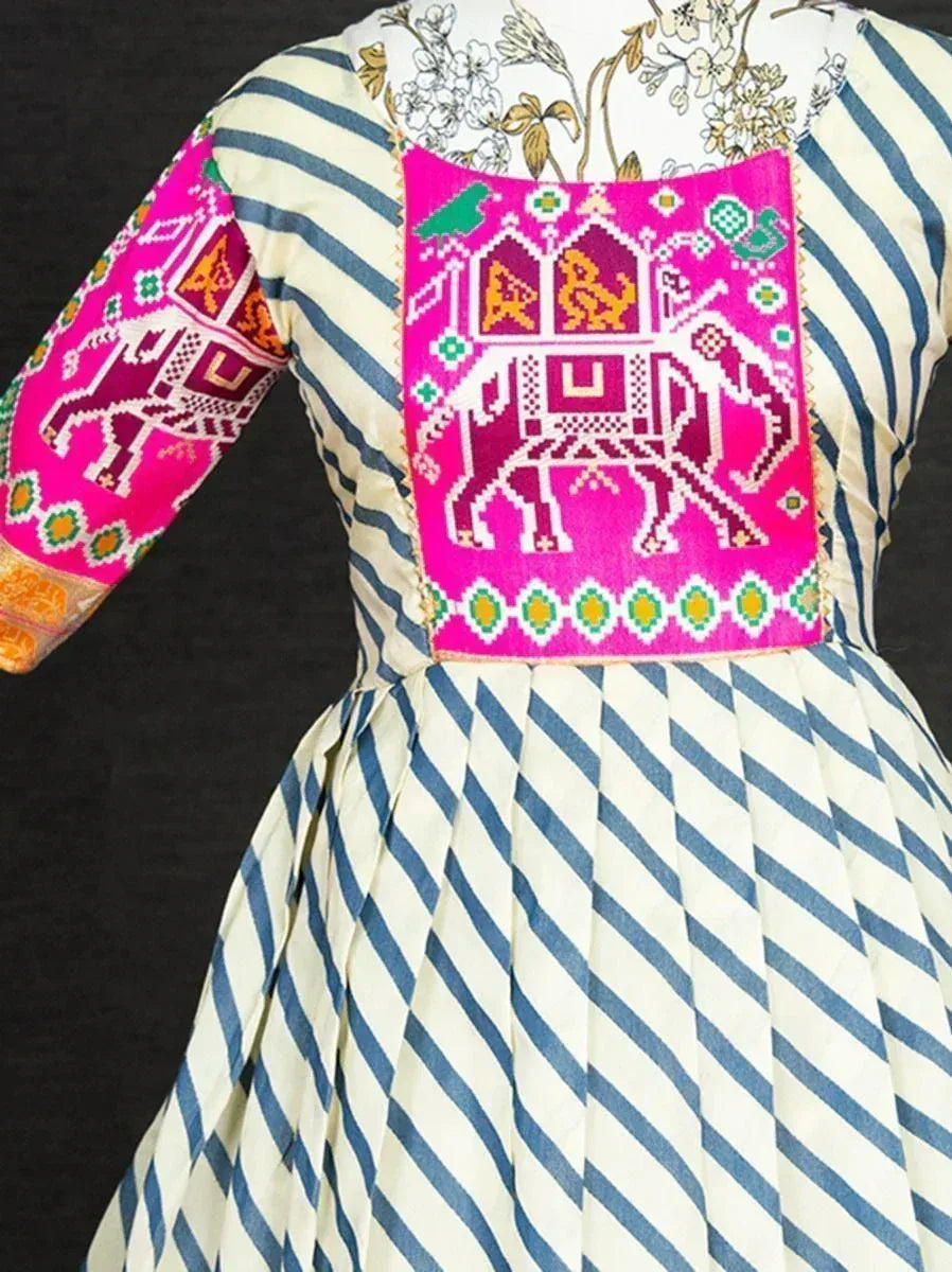 Blue and white striped ethnic gown with vibrant pink elephant embroidery, perfect for Indian festive wear.
