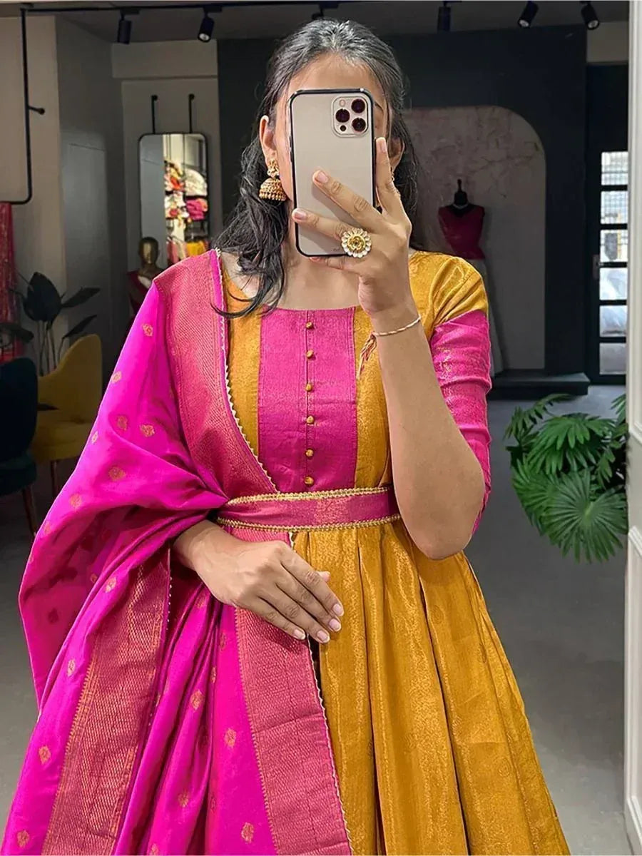 Woman in vibrant pink and gold ethnic gown with matching dupatta, perfect for Indian festive occasions
