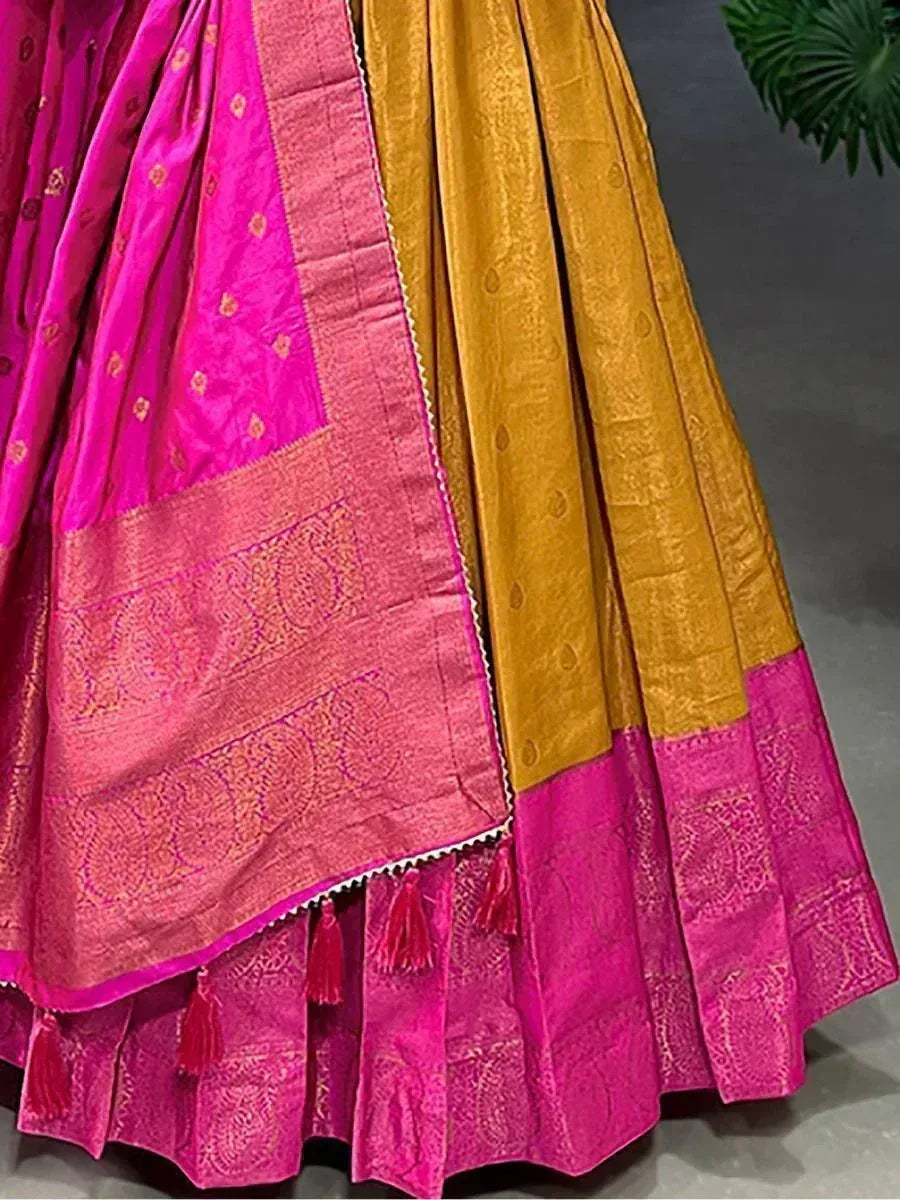 Pink and mustard silk lehenga with intricate gold embroidery and tassels, perfect for Indian ethnic wear