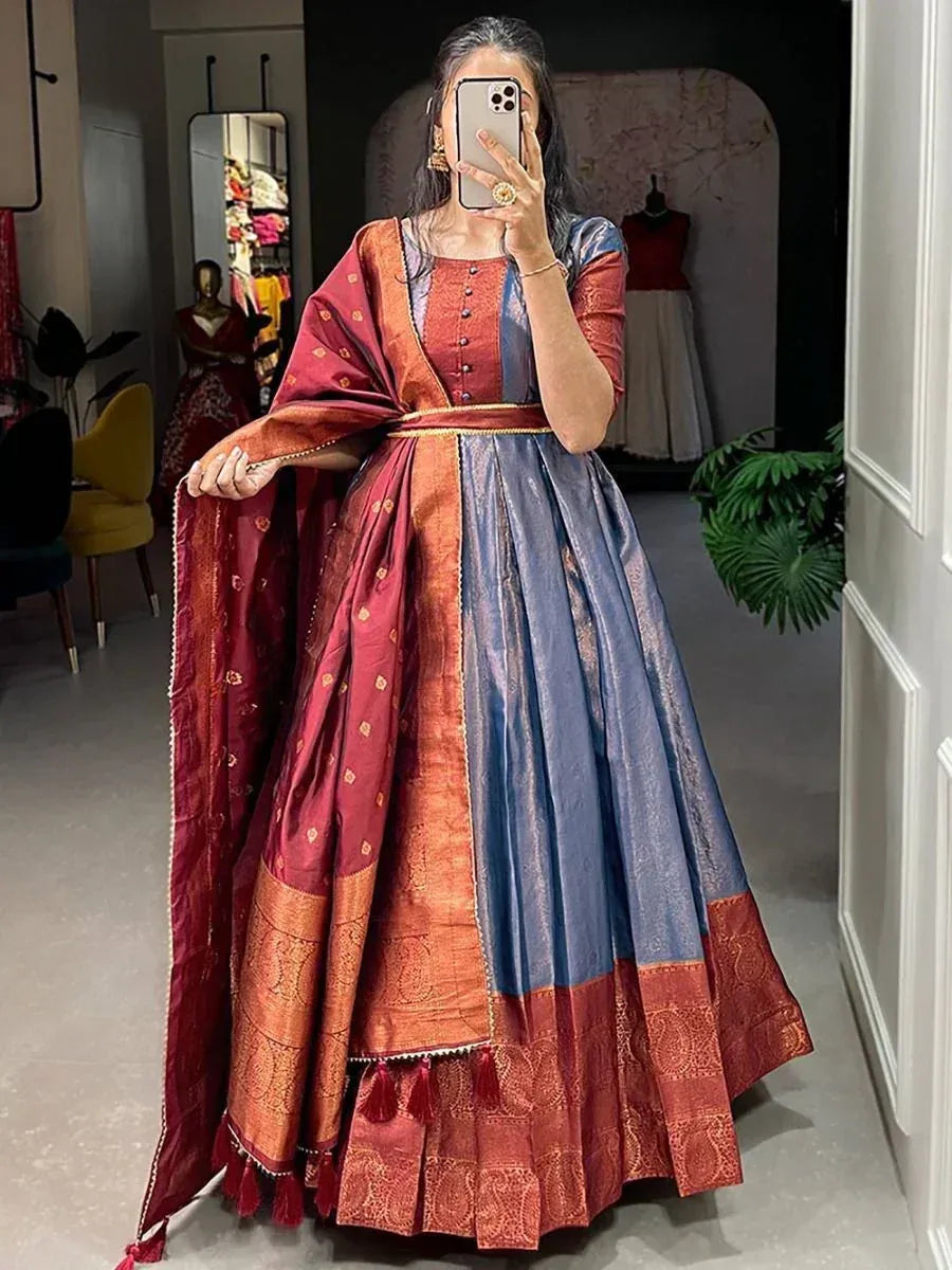 Woman in maroon and blue designer lehenga choli with gold embroidery, perfect for ethnic occasions