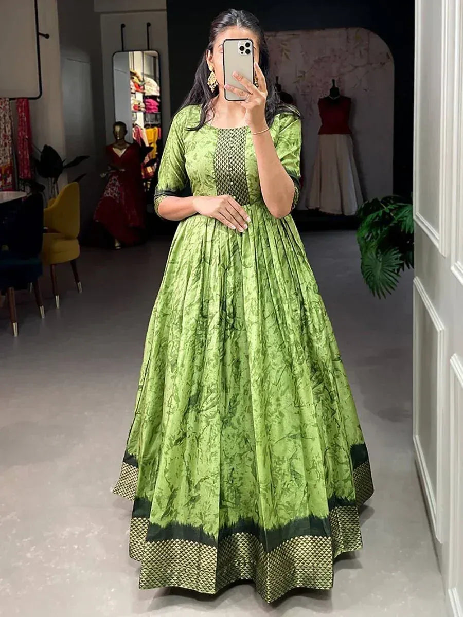 Green ethnic gown with printed pattern and pleated skirt, perfect for Indian occasions