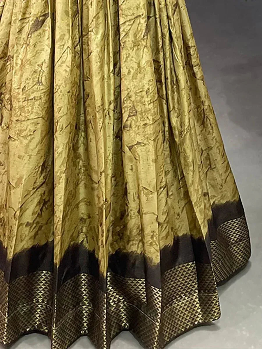 Golden ethnic lehenga skirt with brown border and geometric pattern, ideal for Indian weddings and festivals