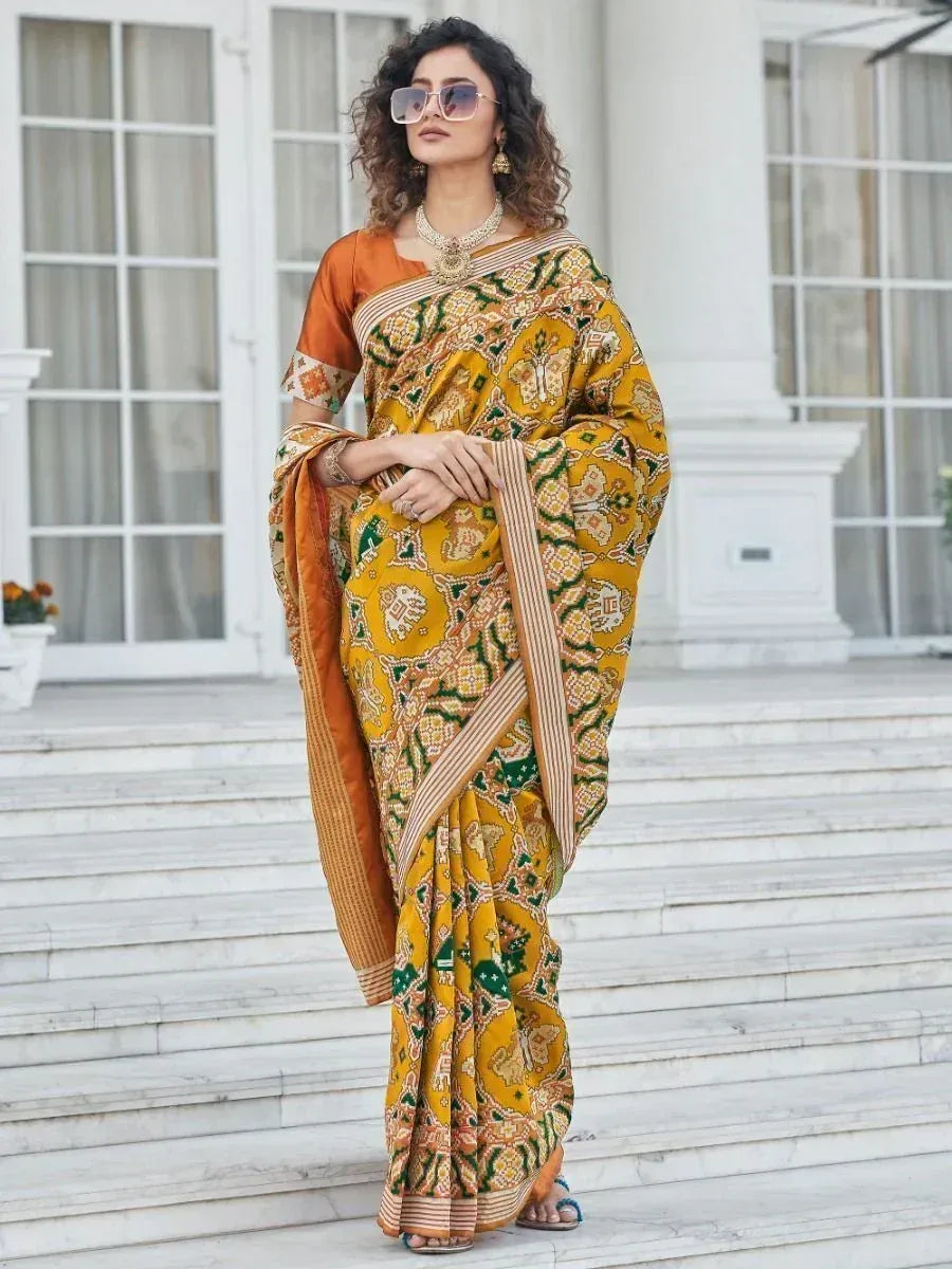 Yellow and green printed saree with orange blouse, styled for ethnic occasions