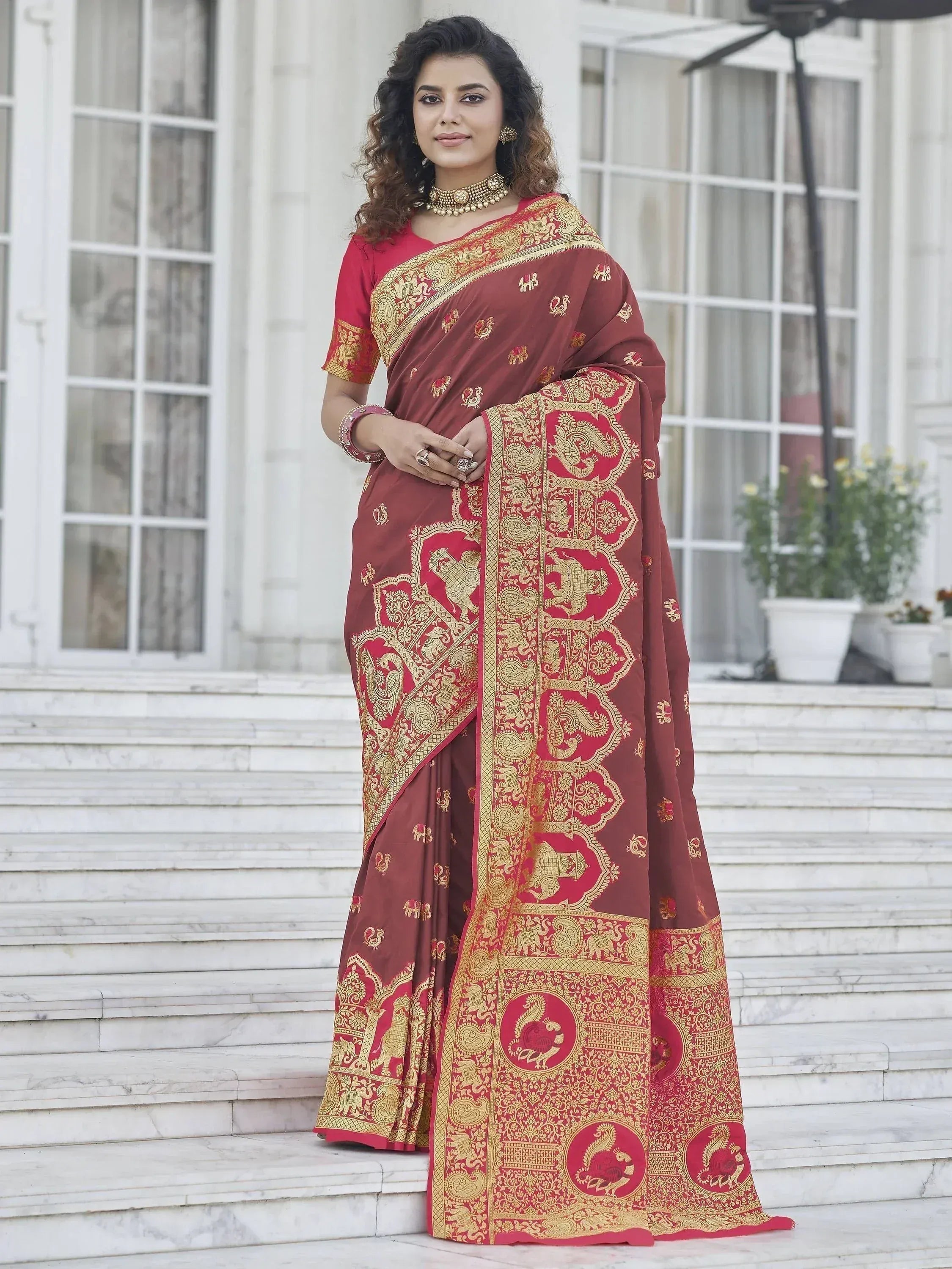 Woman in maroon saree with gold elephant and peacock motifs, perfect for Indian ethnic occasions