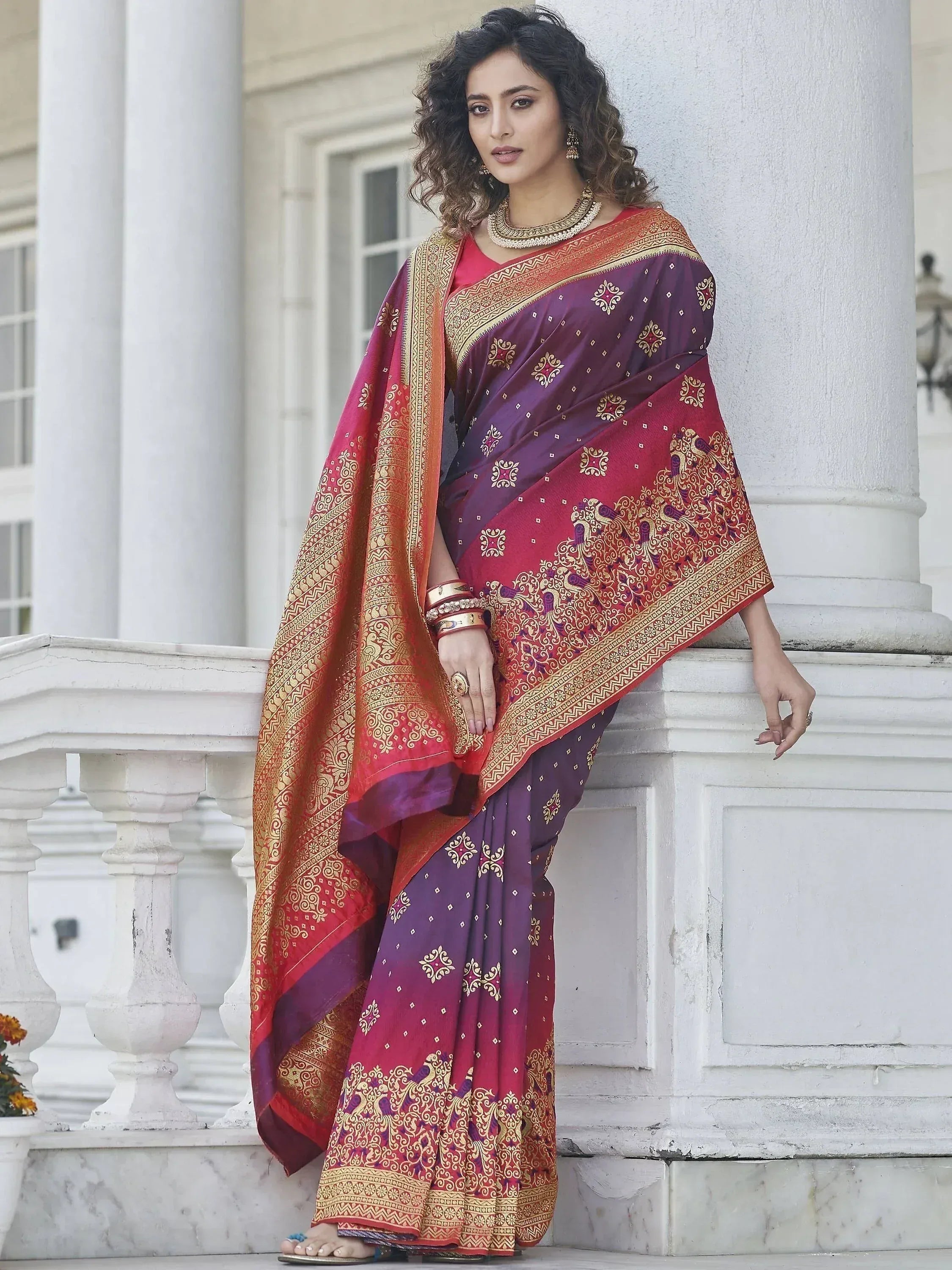 Woman in purple and red designer saree with gold embroidery, traditional Indian ethnic wear