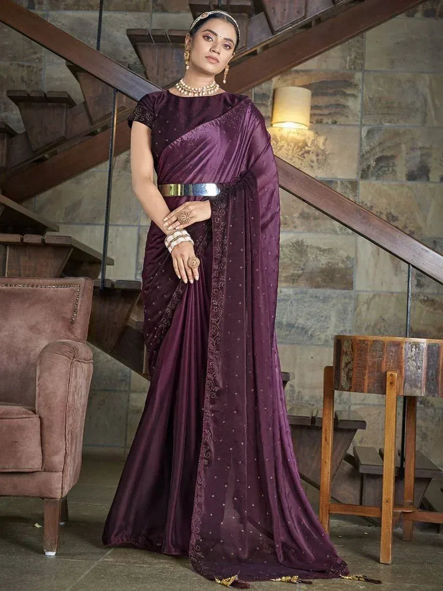 Elegant purple saree with sequin detailing, styled with gold jewelry and a metallic belt for festive occasions