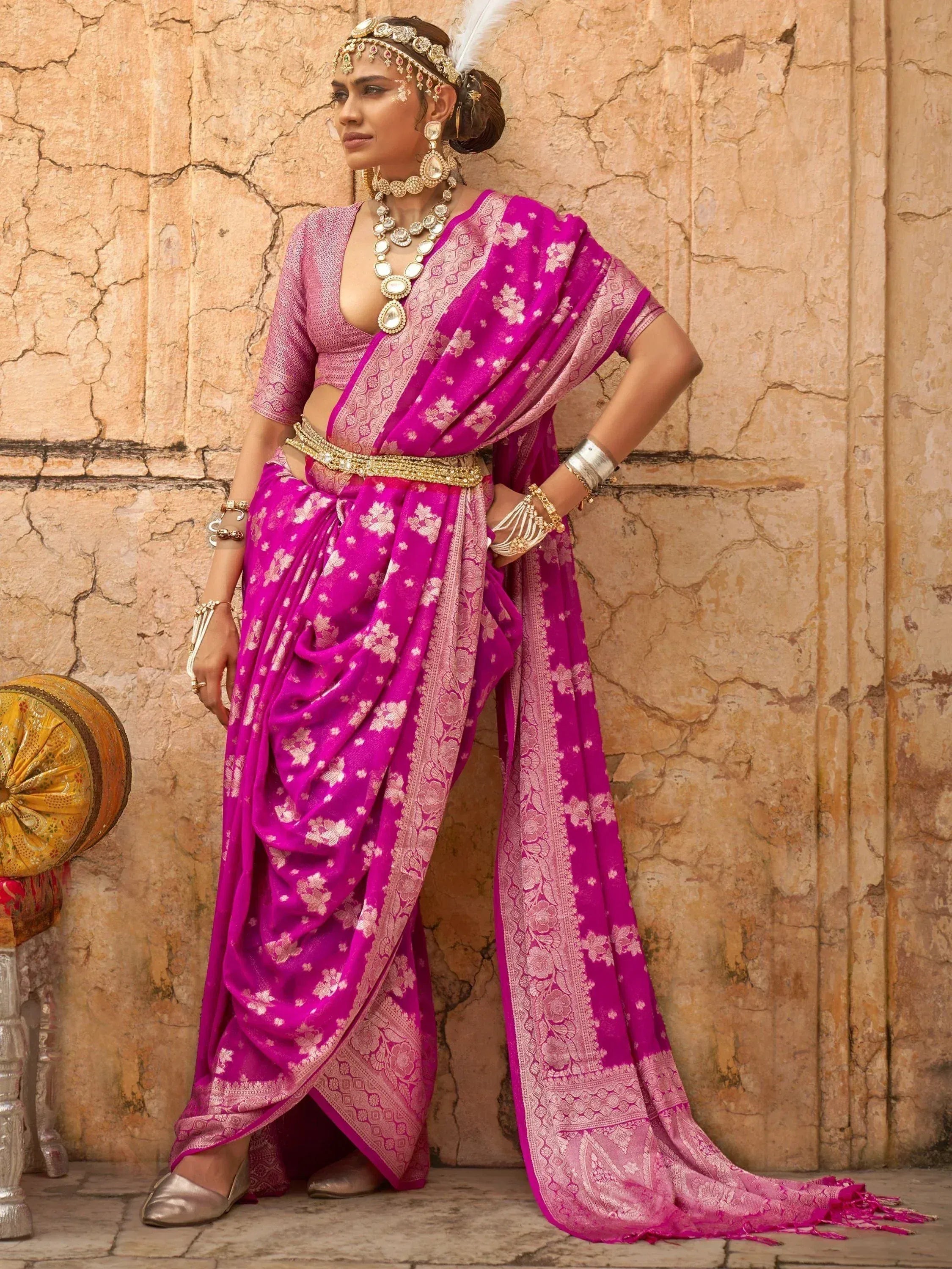 Vibrant pink floral saree with gold embroidery, paired with matching blouse and traditional jewelry, perfect for Indian ethnic occasions.
