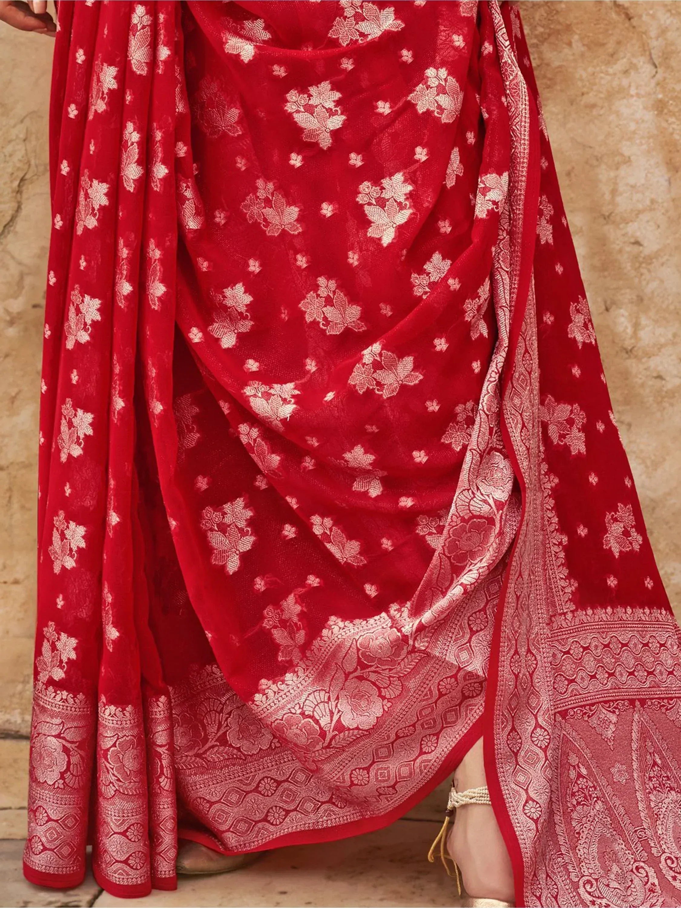 Red floral ethnic saree with intricate gold border, perfect for Indian weddings and festivals