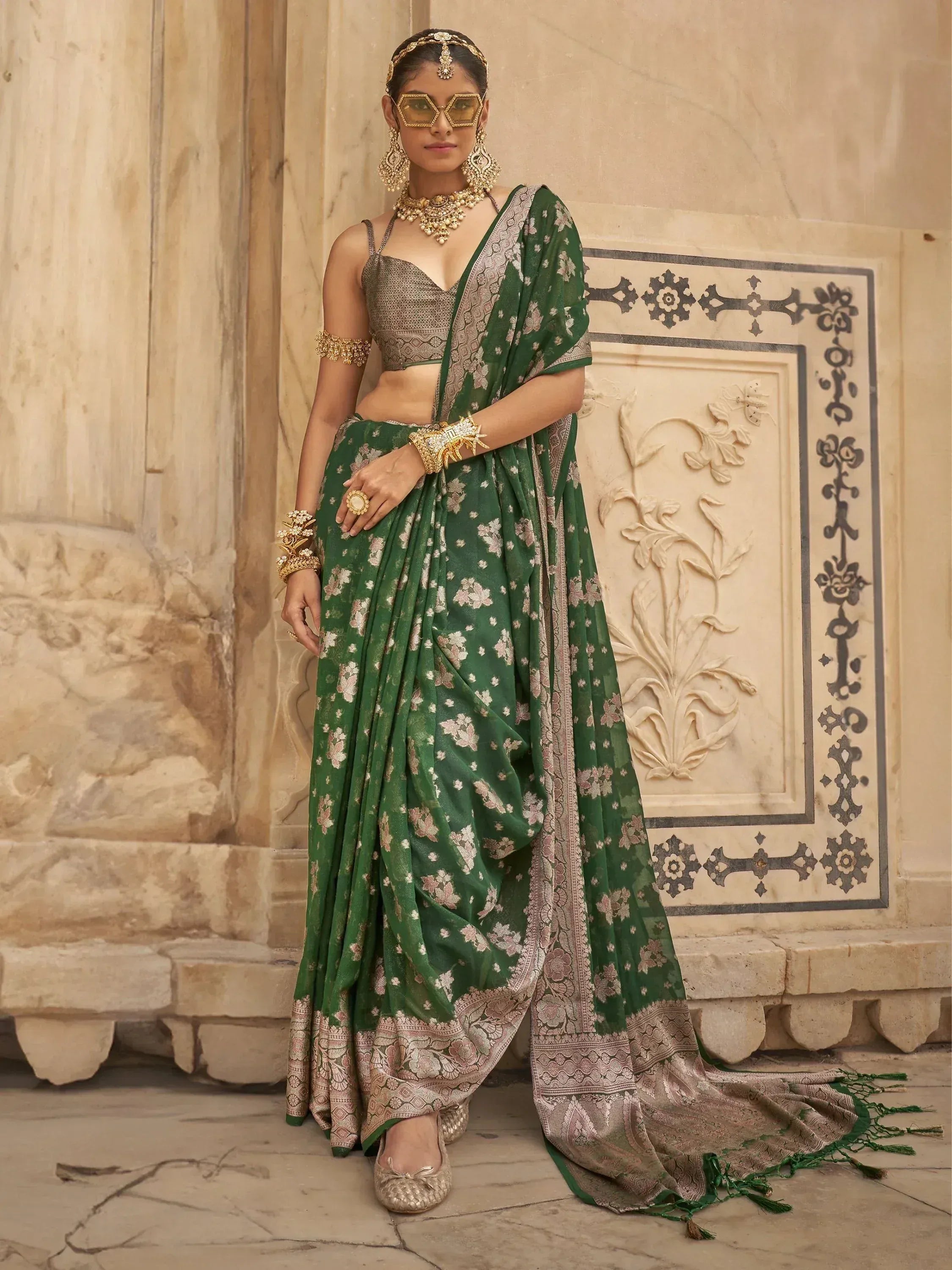 Green floral saree with gold embroidery, paired with designer blouse and traditional jewelry for ethnic wear