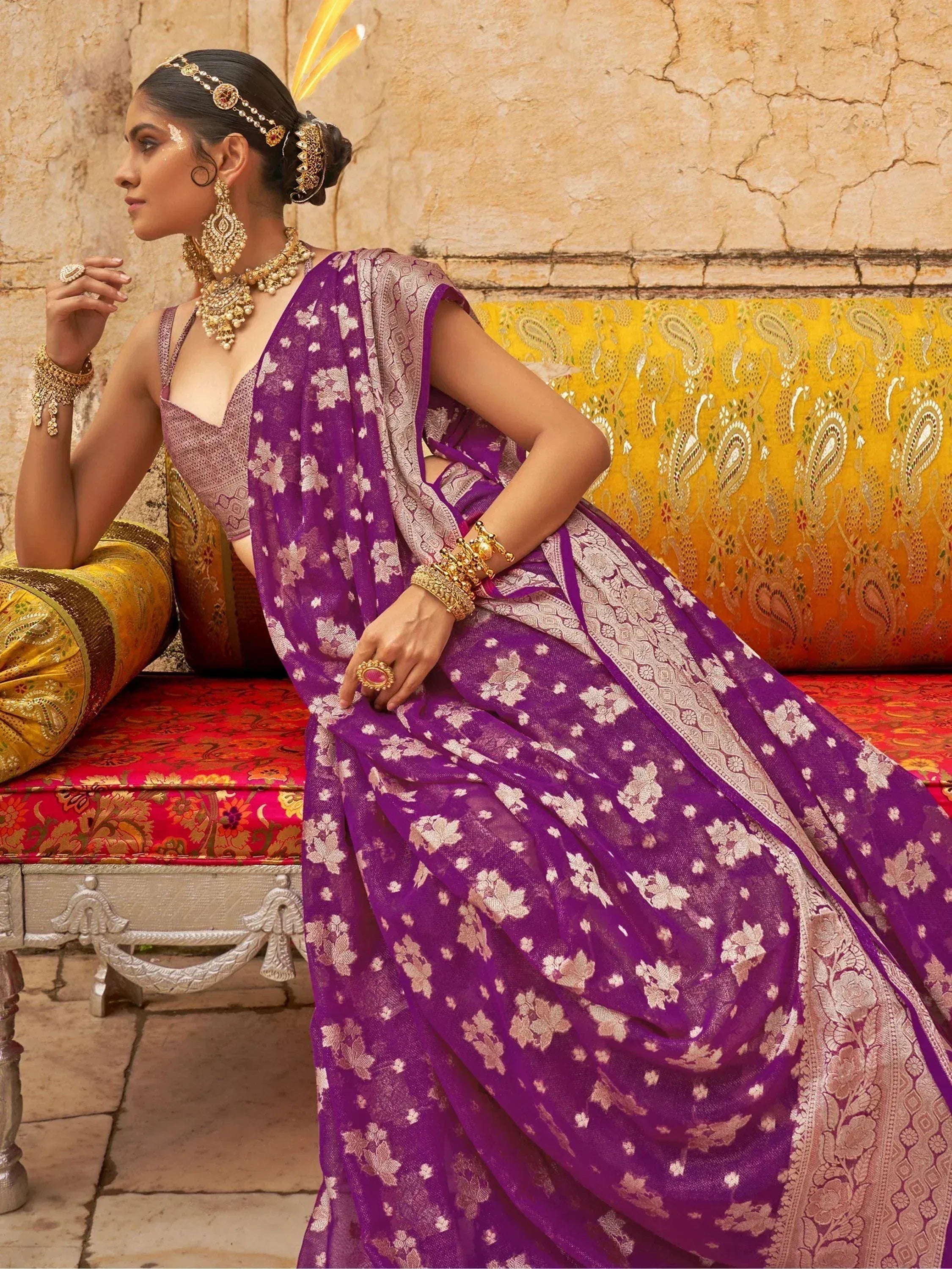 Purple floral saree with gold embroidery, traditional Indian ethnic wear, paired with heavy gold jewelry