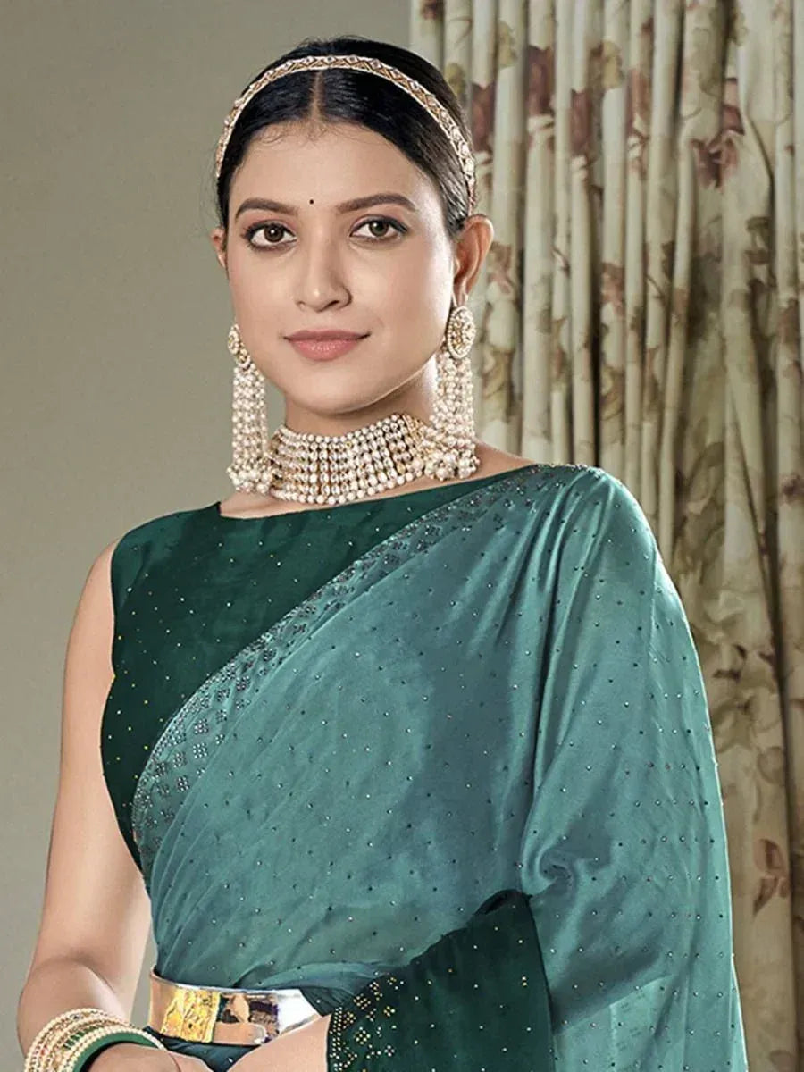 Elegant green saree with sequin detailing, paired with pearl jewelry for Indian ethnic wear