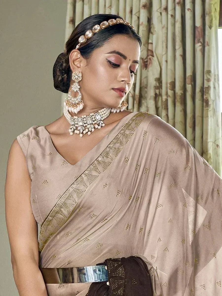 Elegant beige saree with gold embroidery, paired with traditional Indian jewelry for festive occasions.