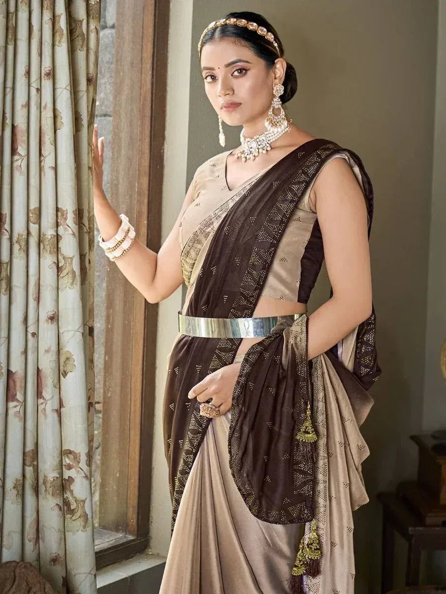 Elegant brown and beige saree with gold embroidery, paired with traditional jewelry for Indian ethnic wear