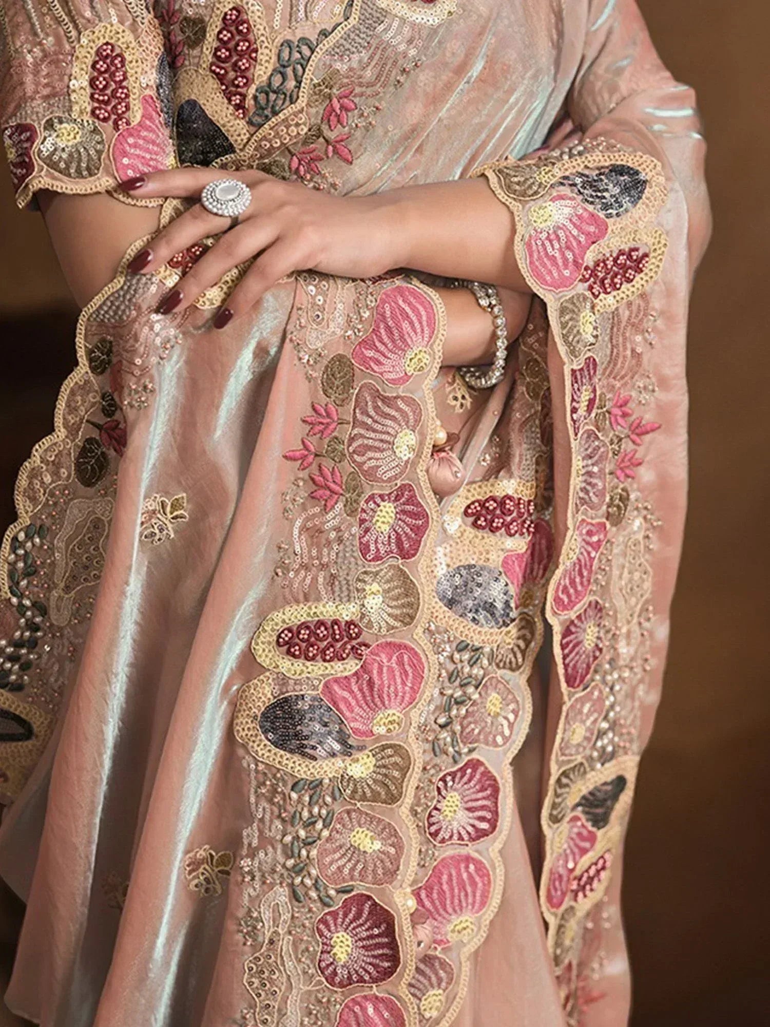Elegant Indian ethnic wear with floral embroidery and sequin detailing on soft pastel fabric
