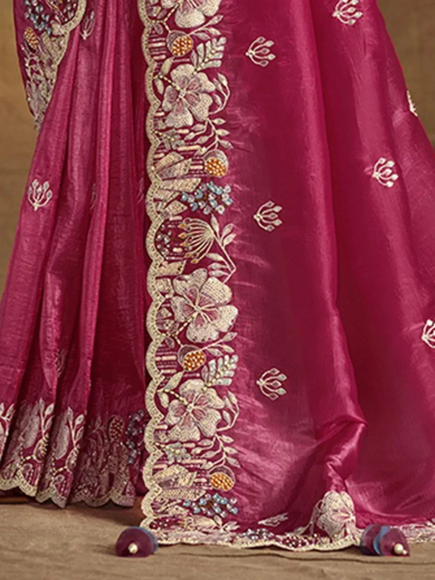 Rich magenta lehenga with intricate floral embroidery and scalloped border, perfect for Indian ethnic wear.