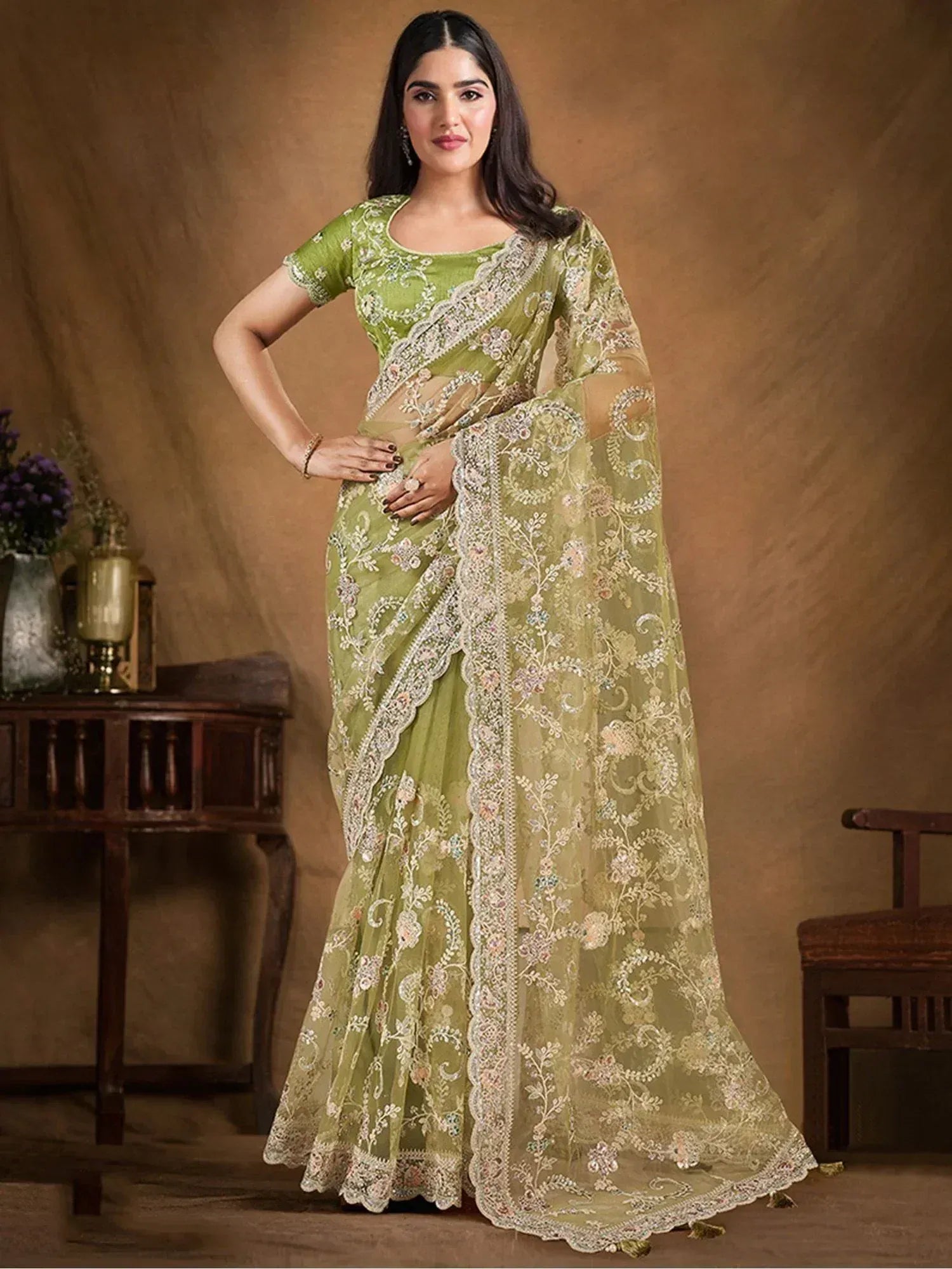 Elegant green embroidered saree with floral lace detailing, perfect for Indian ethnic occasions